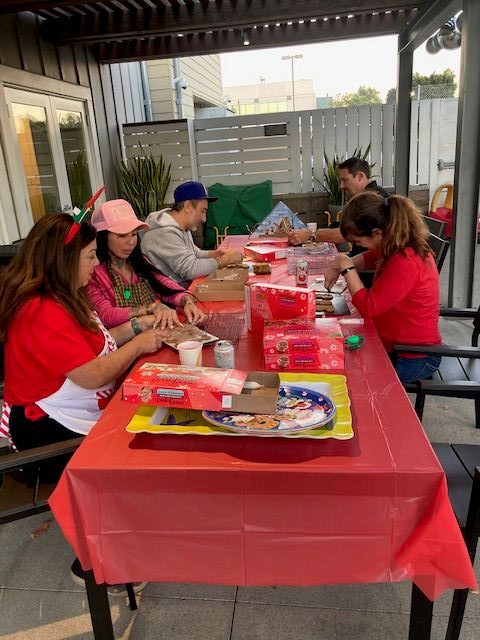 Volunteers decorate holiday cookies at Ronald McDonald House of Long...
