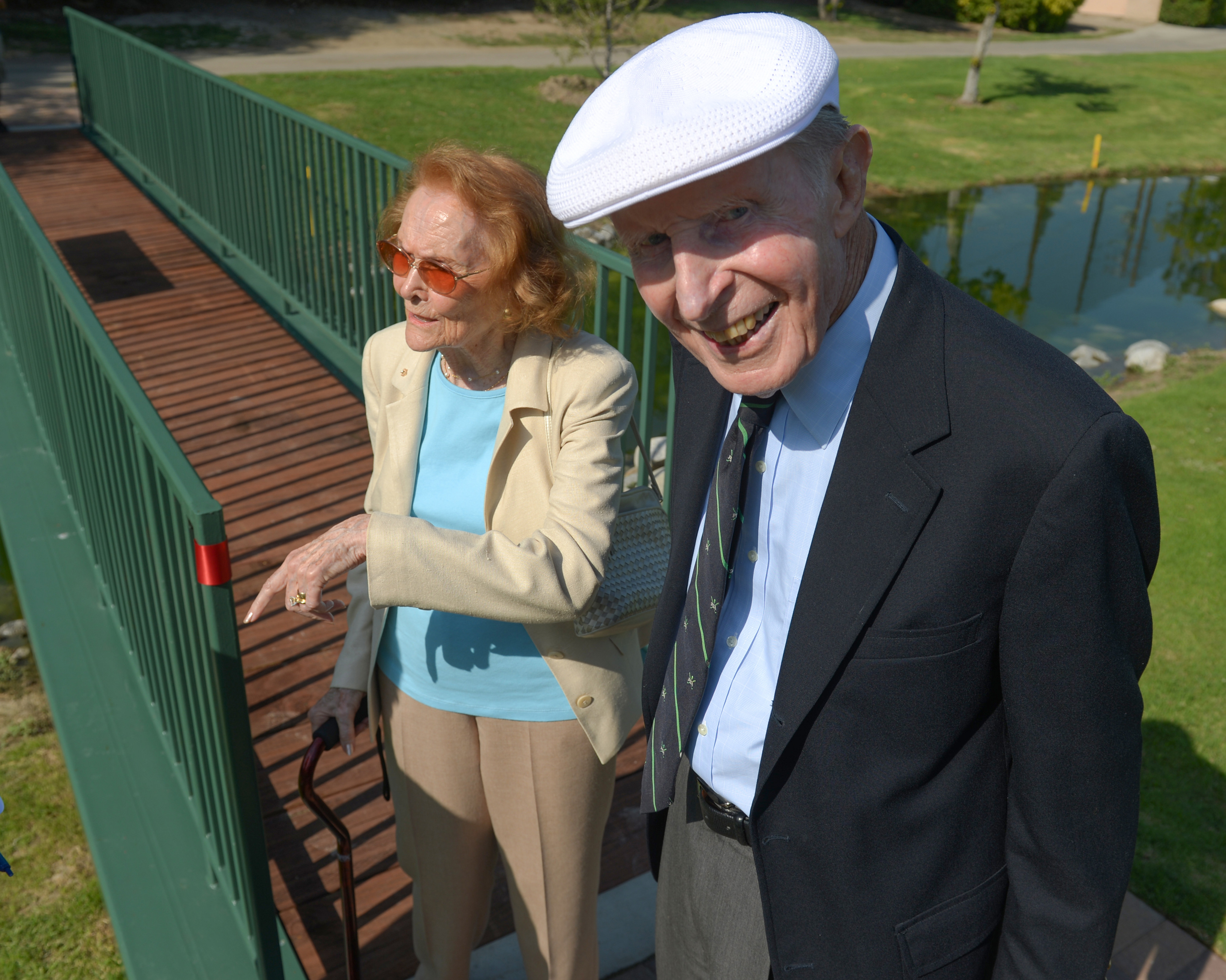 Len Kennett and his wife Marie stand at the end...