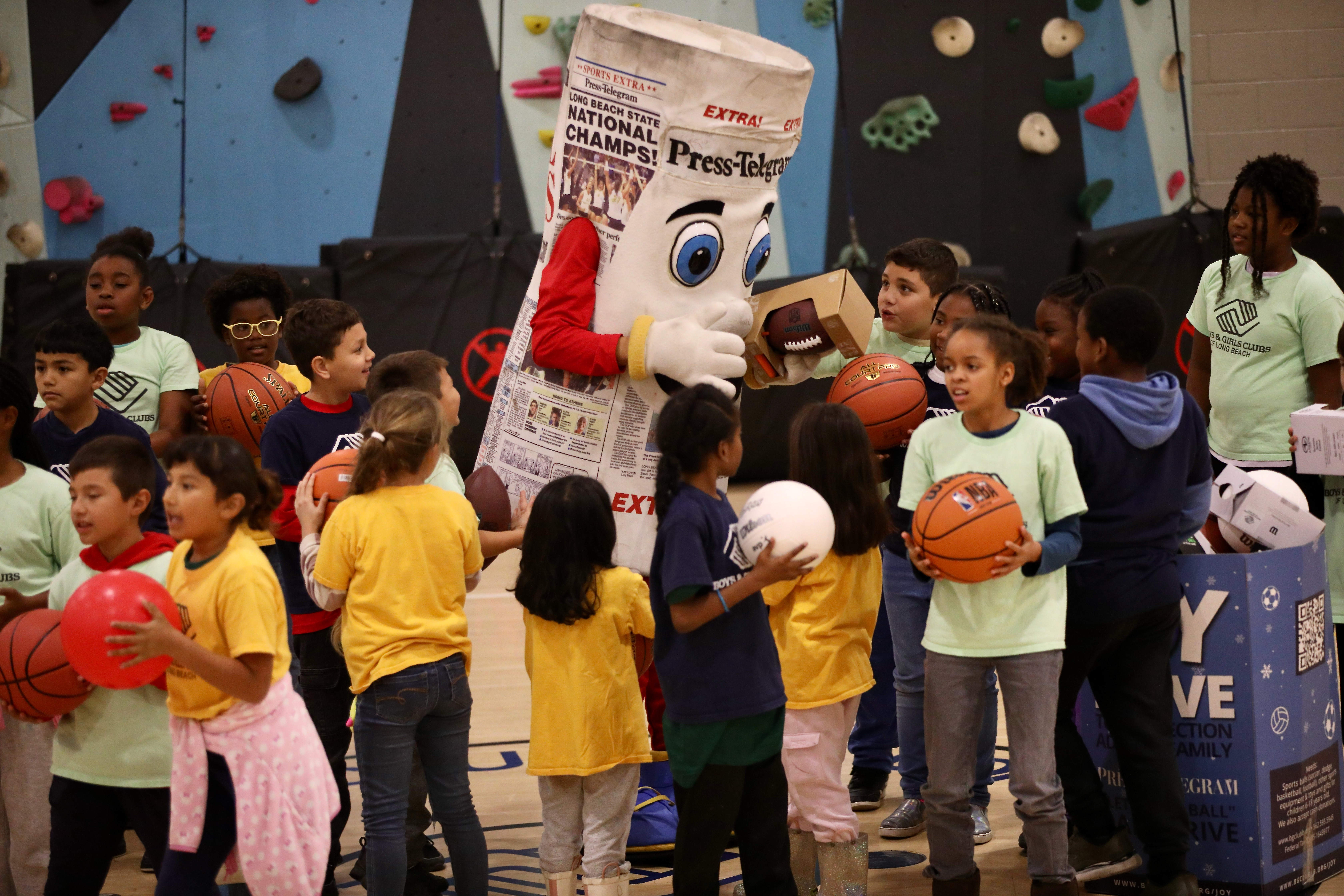 Long Beach Boys & Girls Club members interact with Petey,...