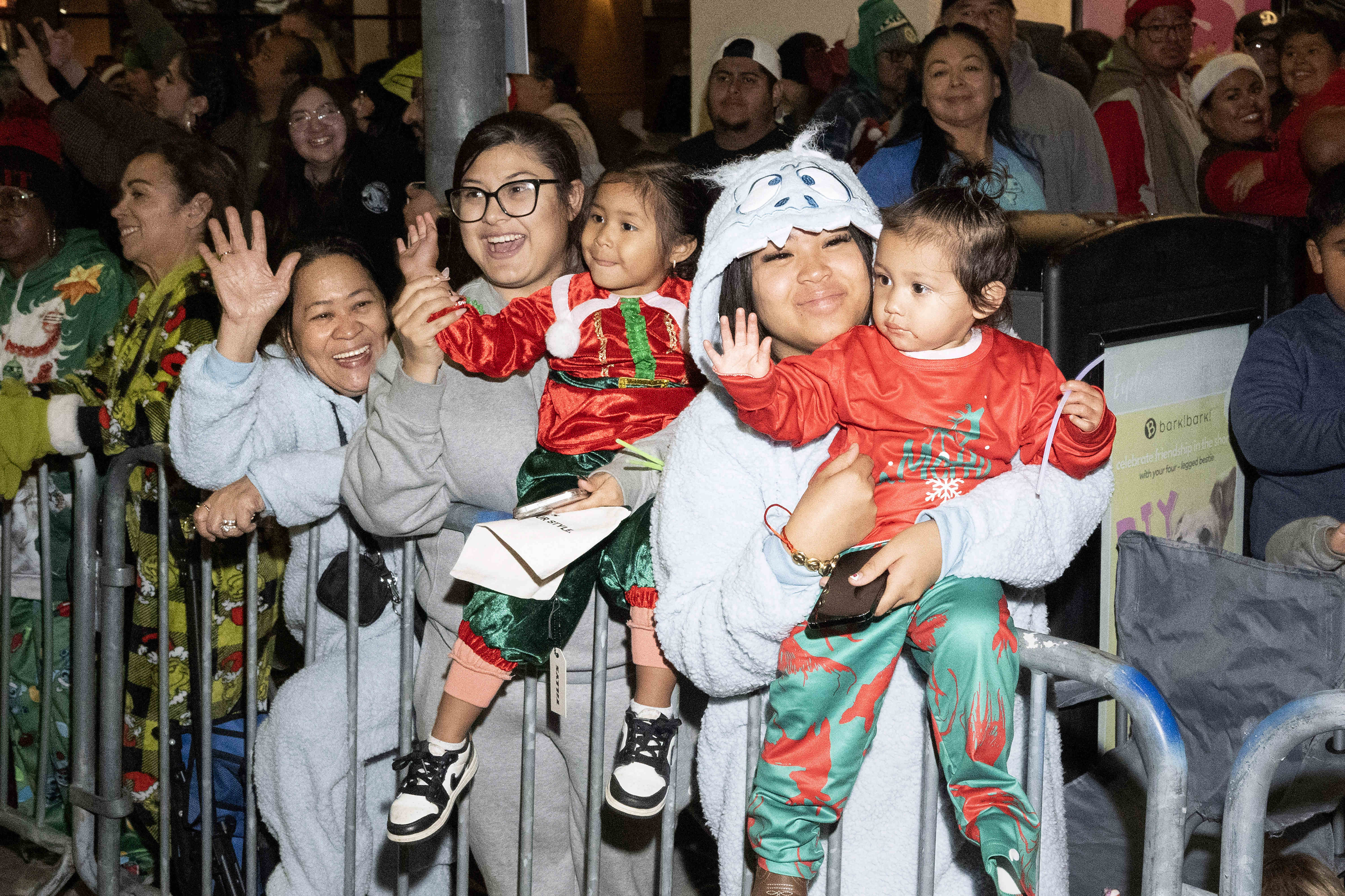 Attendees of the 41st Belmont Shore Christmas Parade cheer and...
