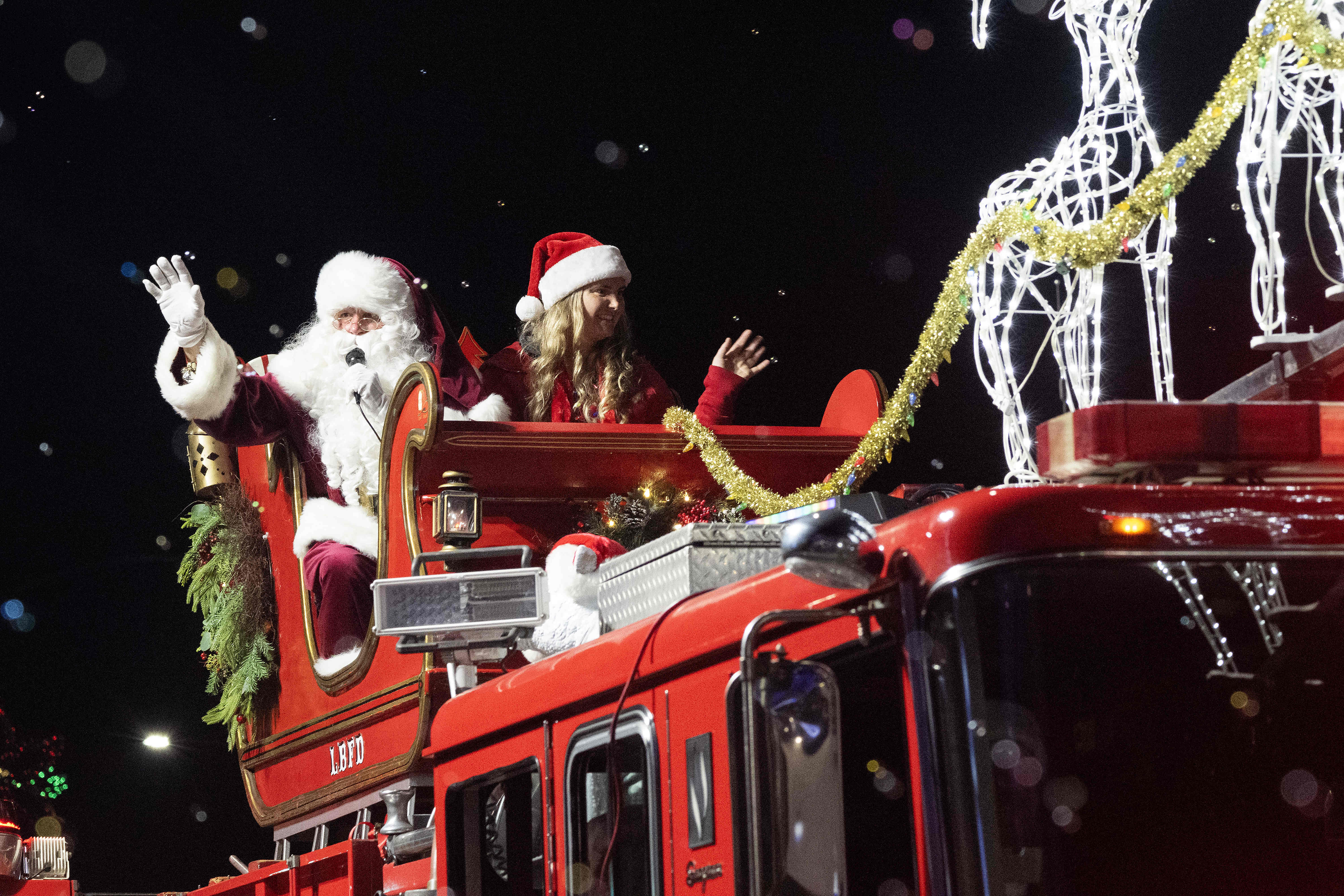 Santa waves to attendees of the 41st Belmont Shore Christmas...