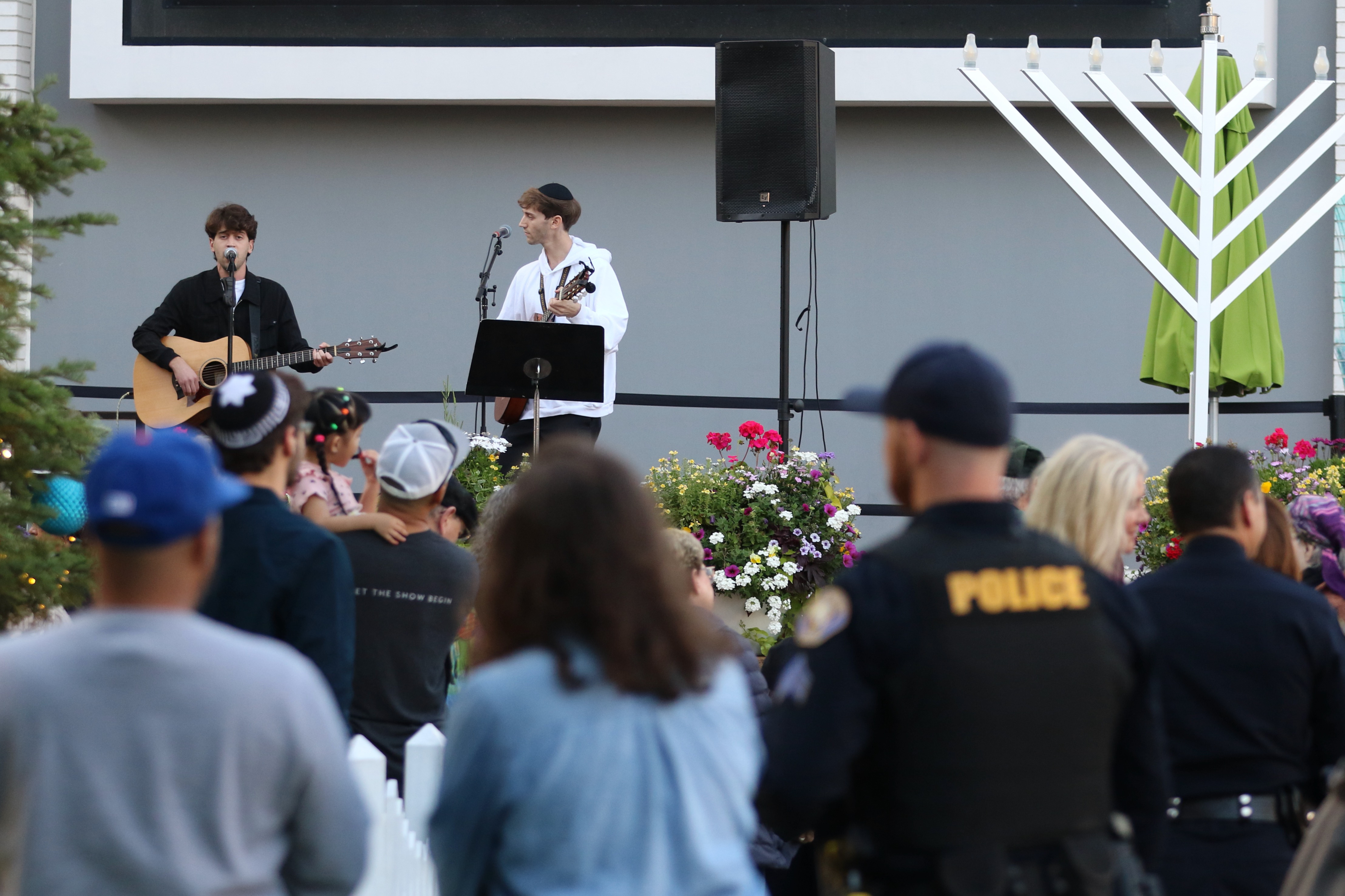A police officer walks through the crowd on Sunday, Dec....