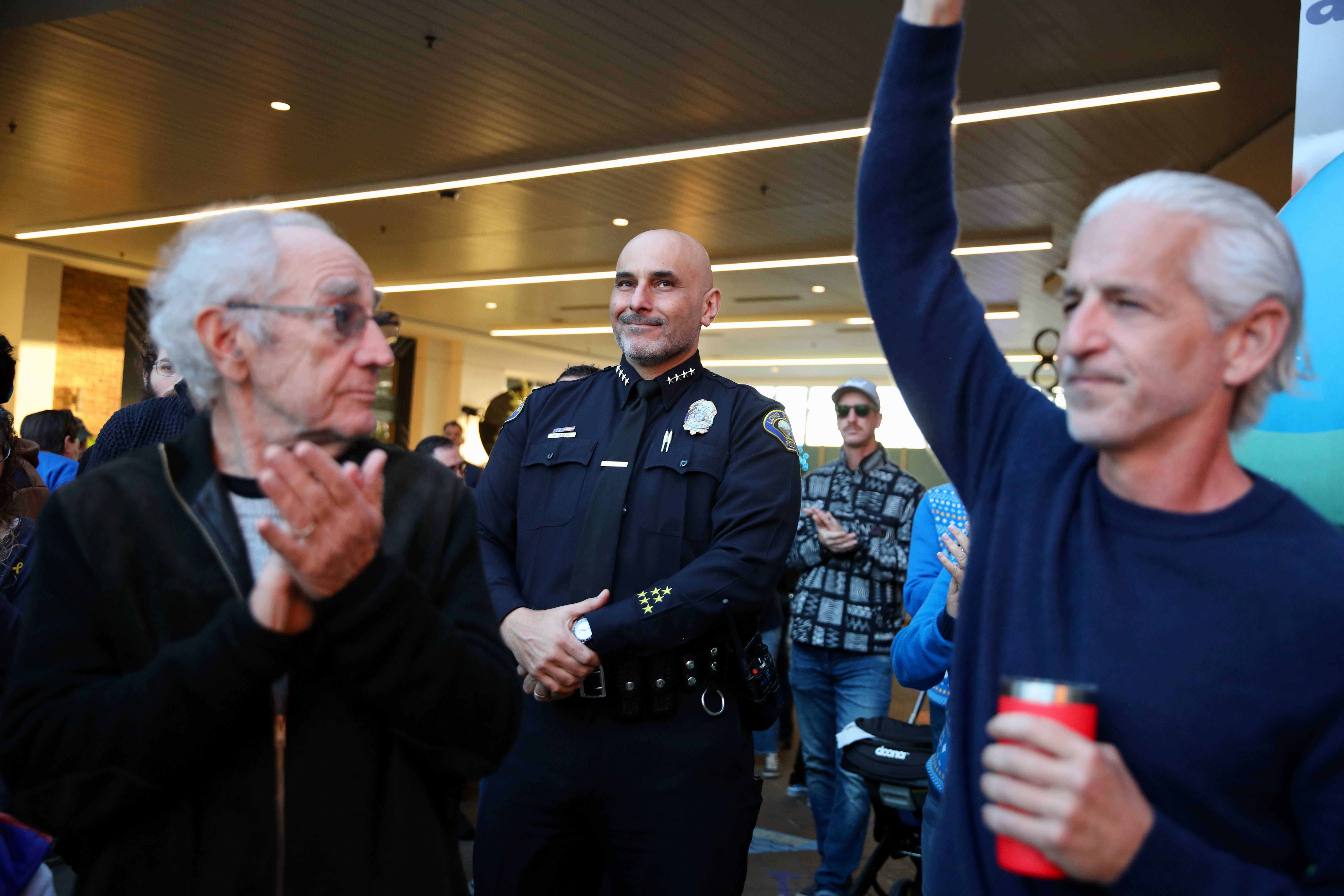 Long Beach Police Chief Wally Hebeish is applauded and cheered...