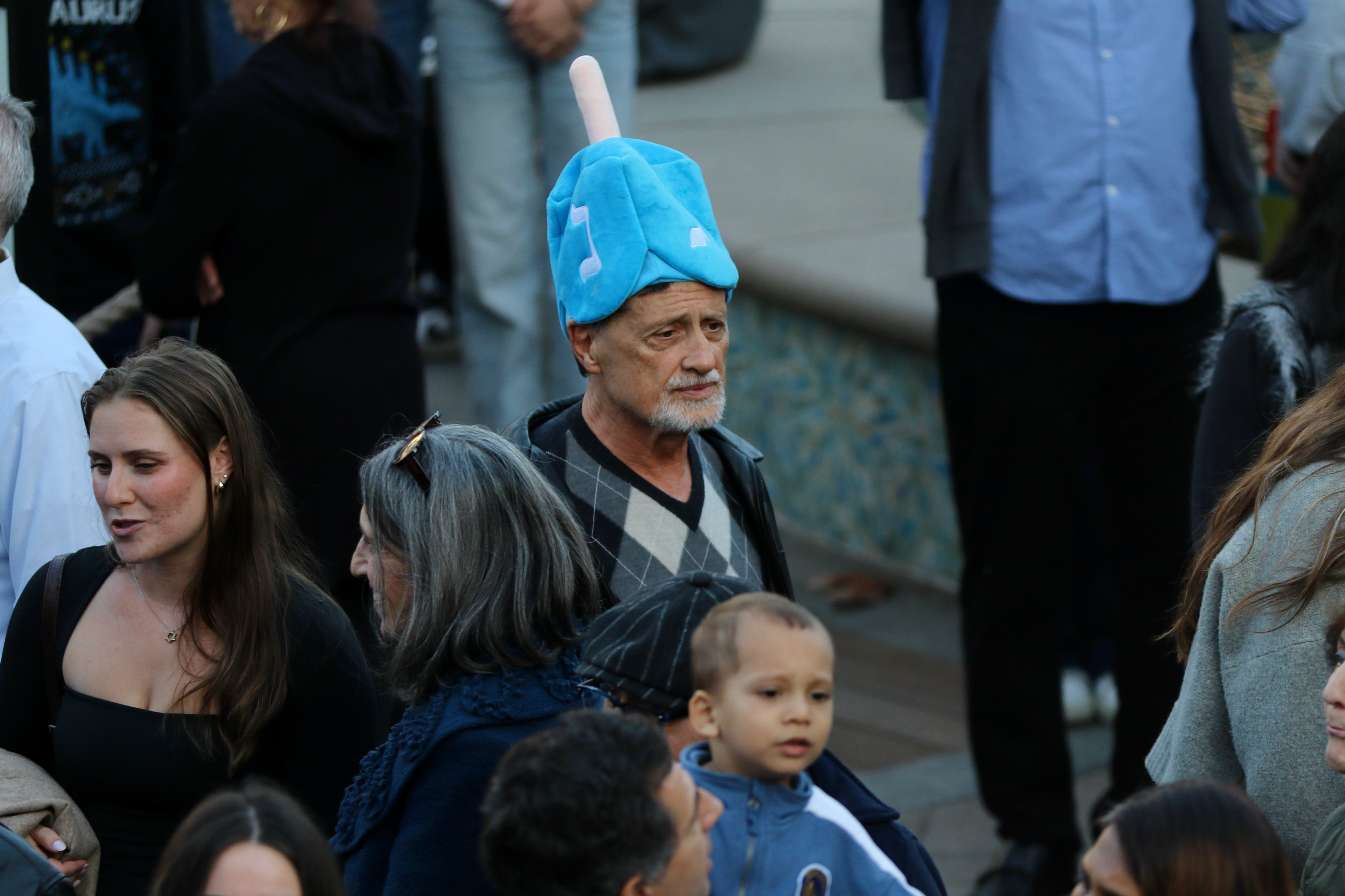 Celebrants attend a Hanukkah menorah lighting event on Sunday, Dec....
