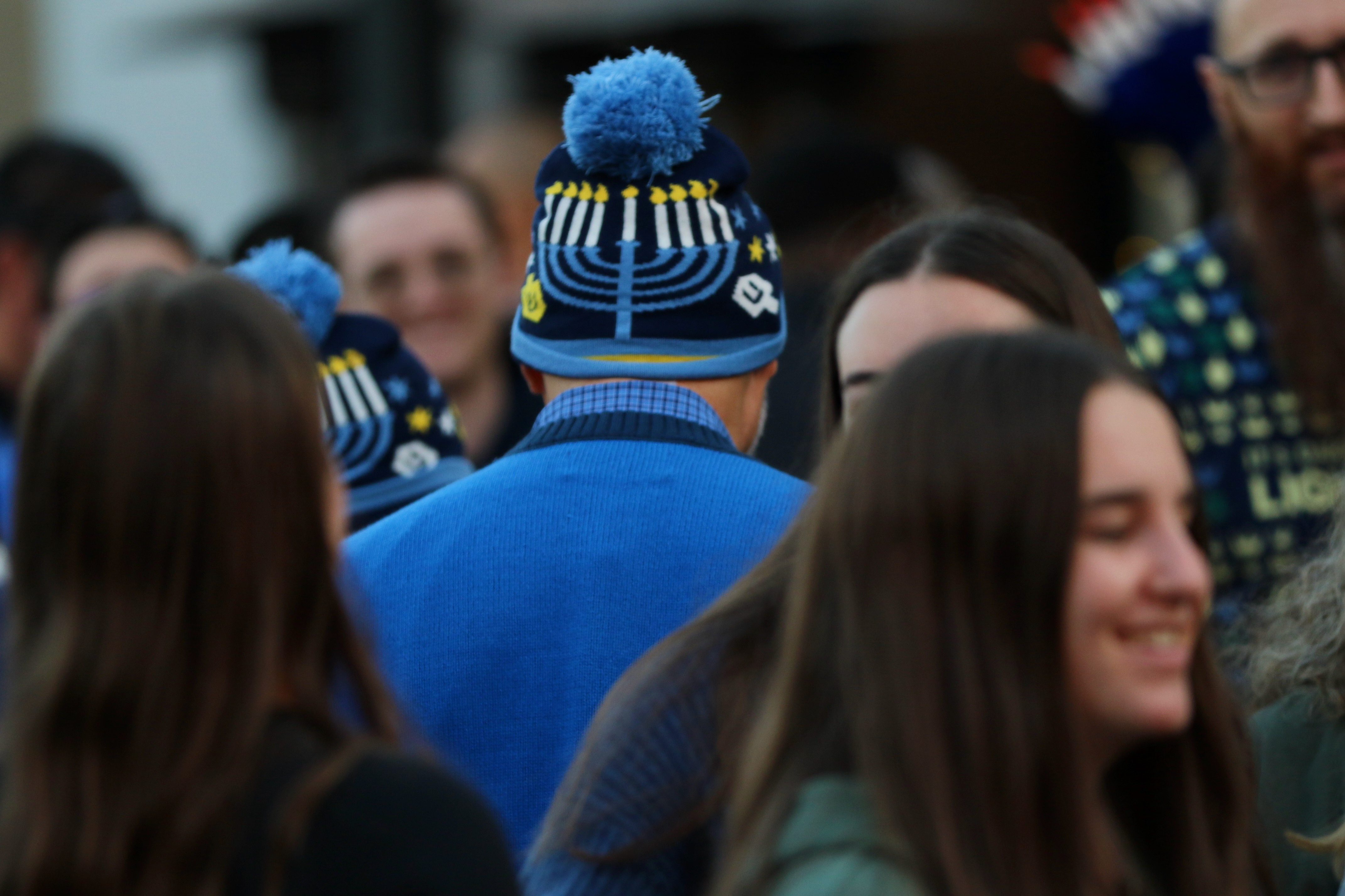 Celebrants attend a Hanukkah menorah lighting event on Sunday, Dec....