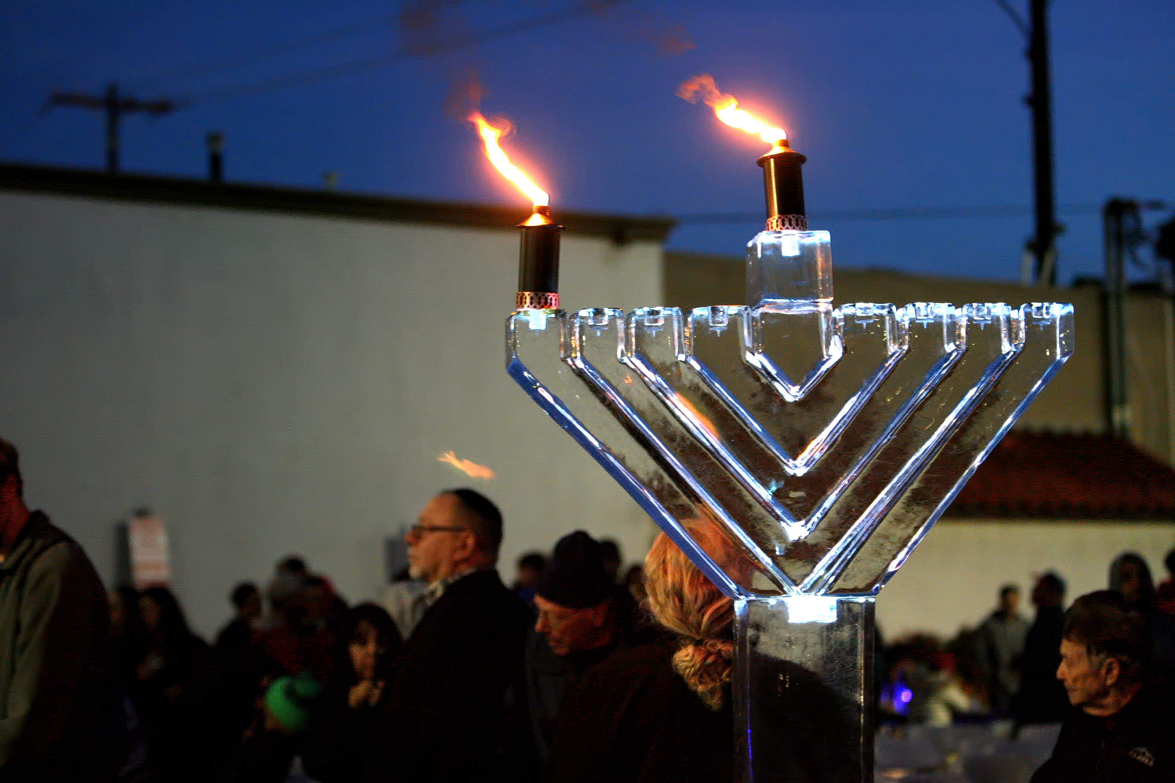 The Menorah is seen lit after sunset during the Chanukah...