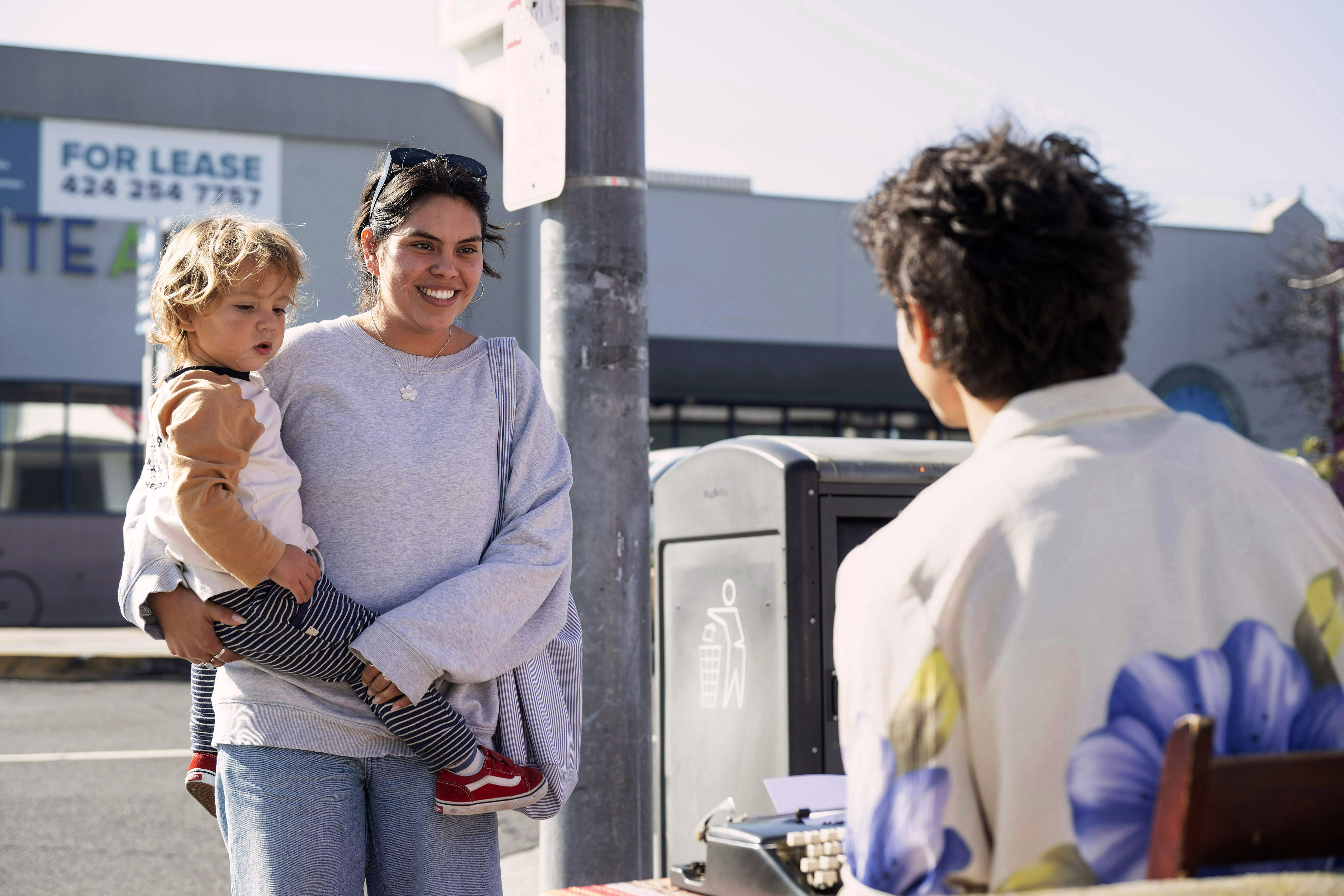 From right, Nico Patino writes a poem for Natalie Dominguez...