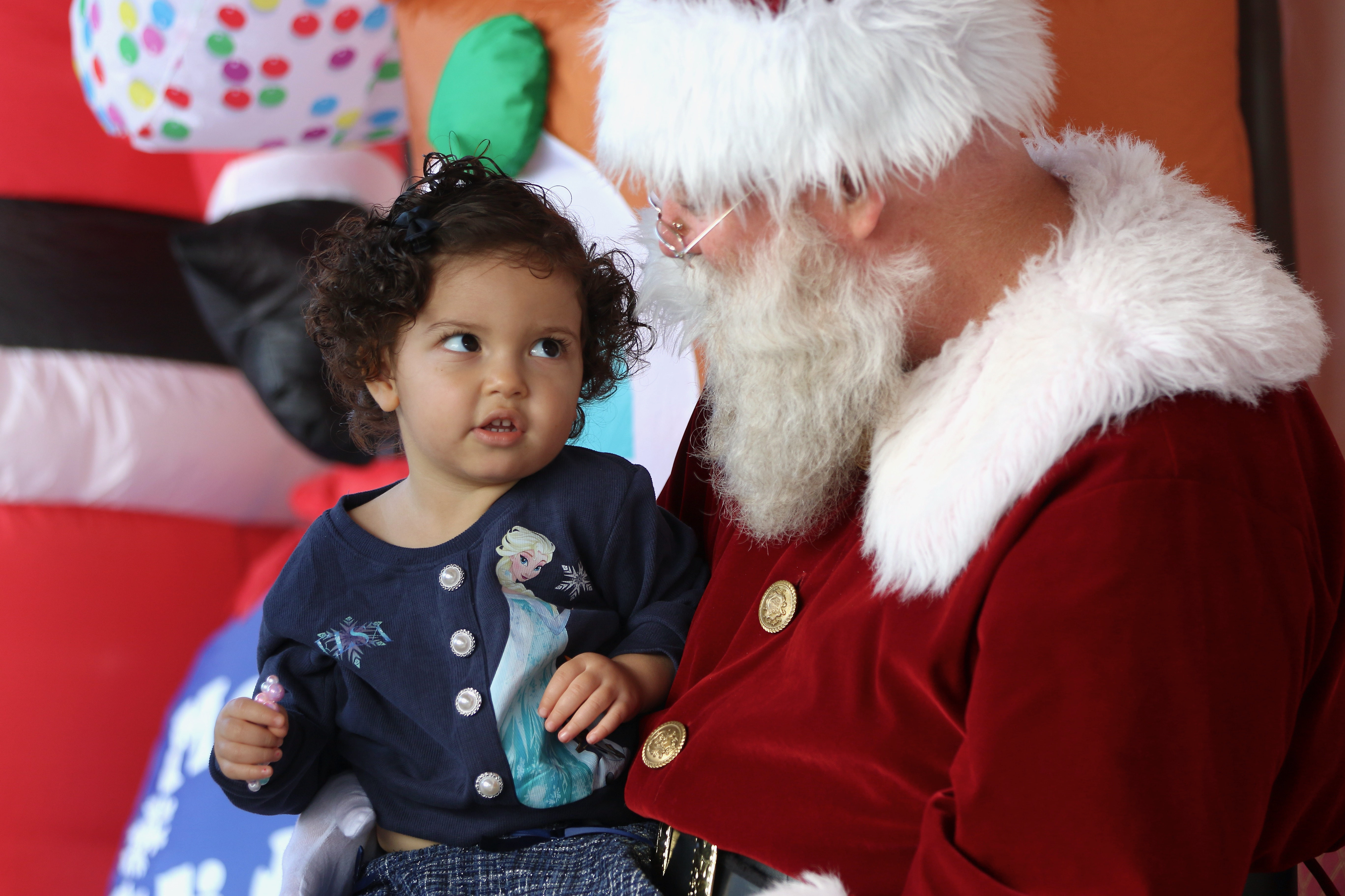 Zaynah Gonzalez, 2, has a word with Santa Claus at...