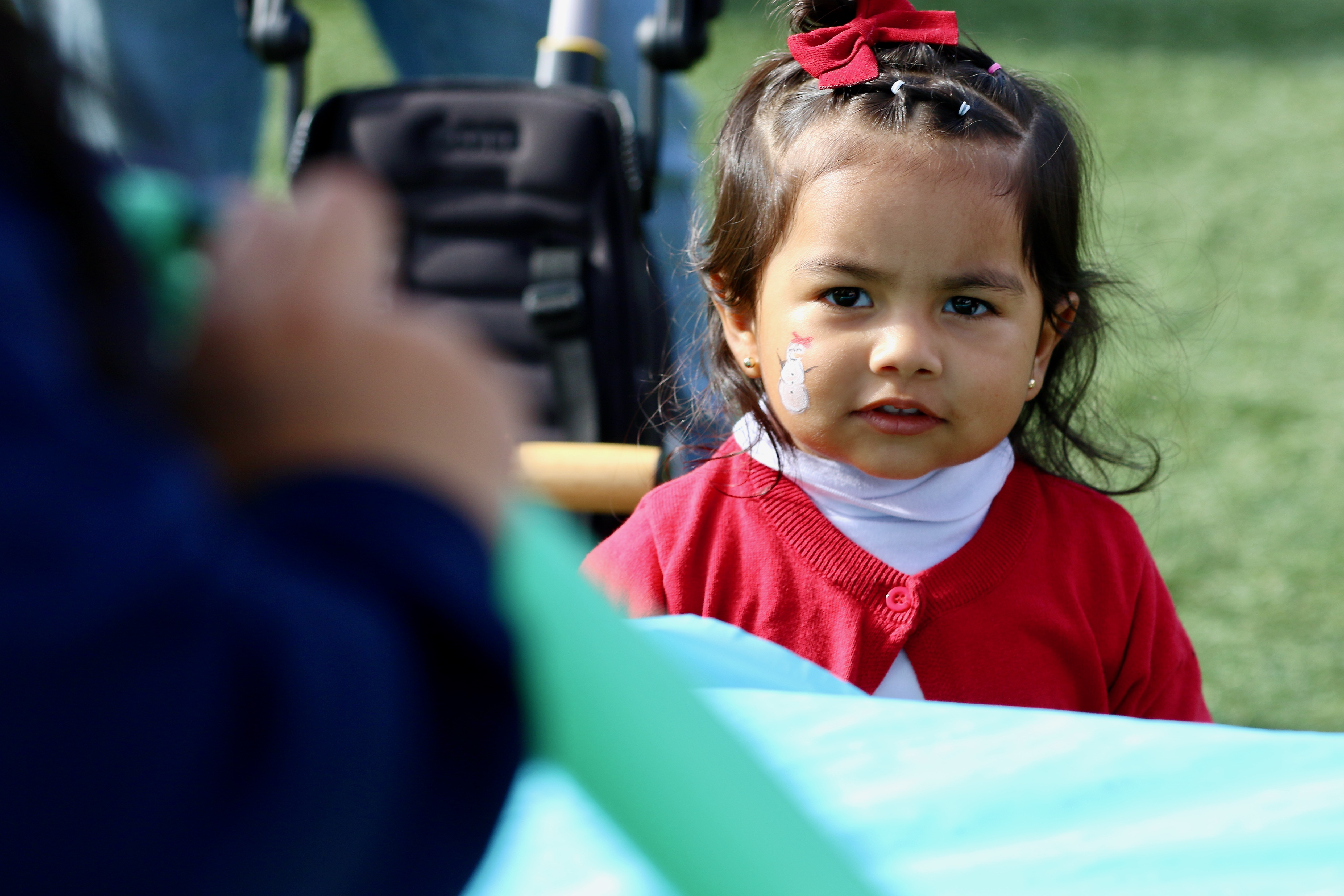 A youngster is focused on a balloon artist at Winter...