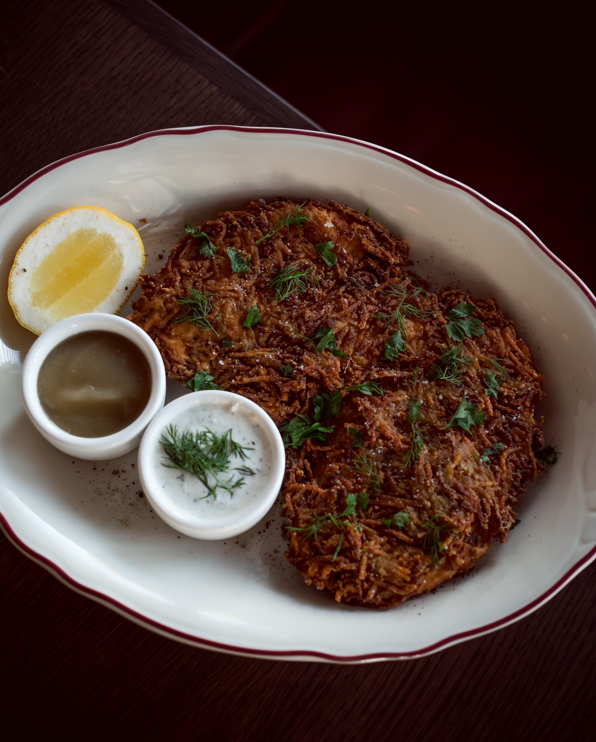 Latke chicken schnitzel with dill creme fraiche, apple compote.