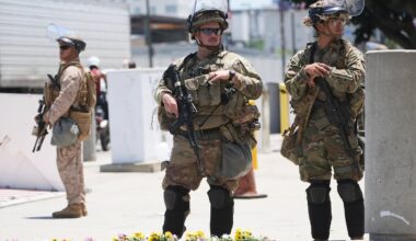 Members of the California National Guard and U.S. Marines guard a federal building in June 2023, in Los Angeles.