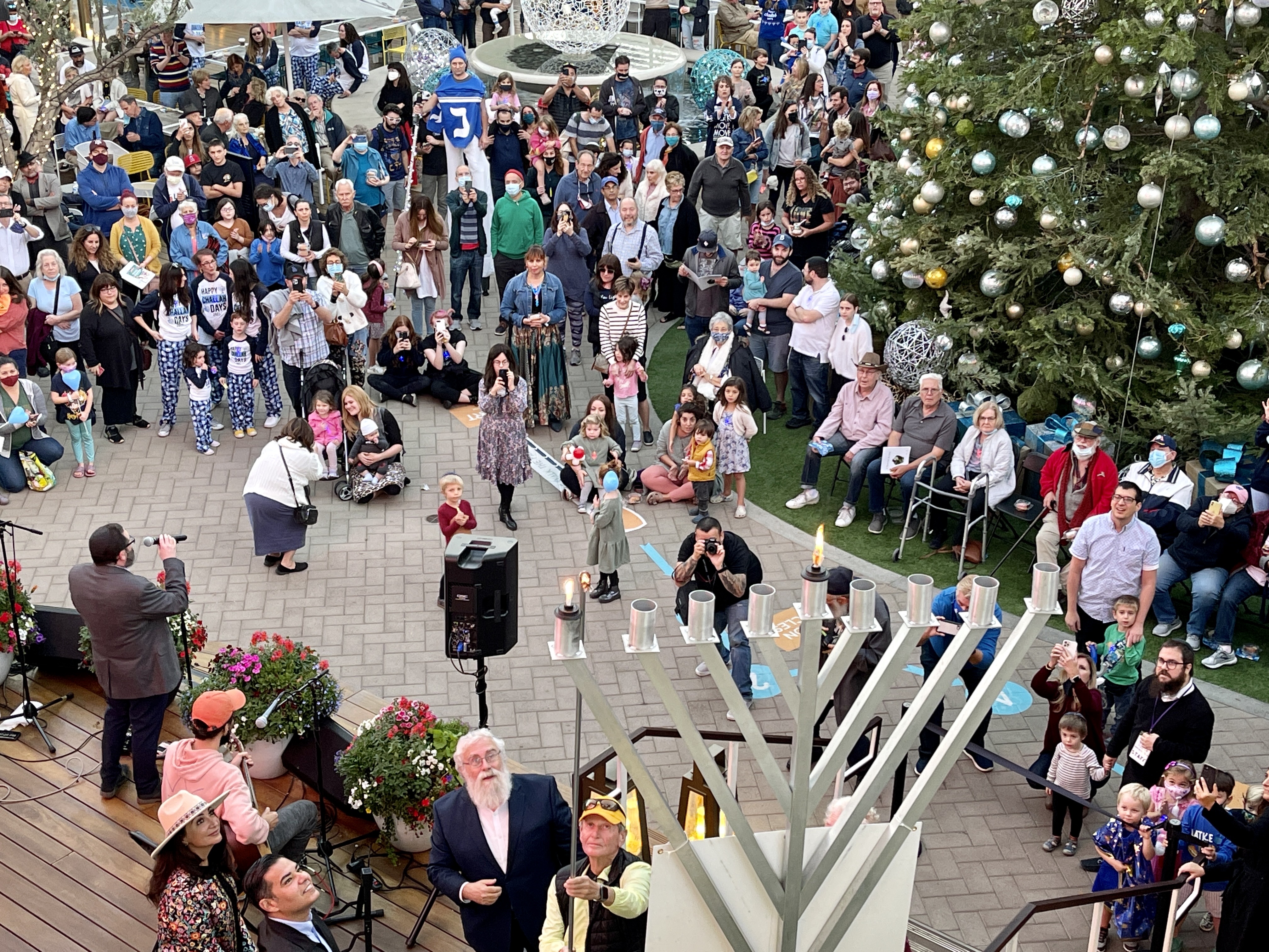 Visitors at PCH & 2nd. watch as giant menorah is...