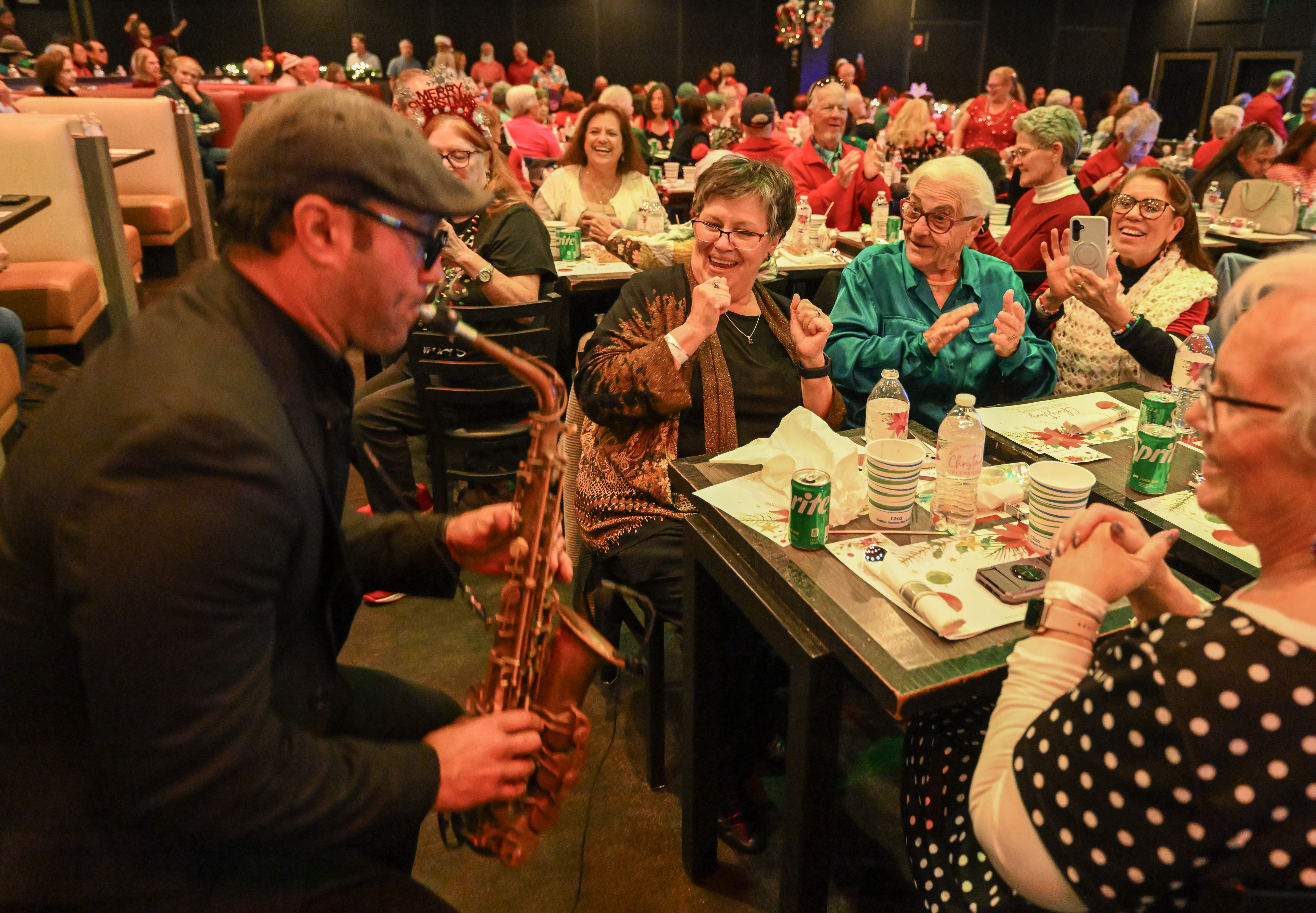 Dennis Rodriguez, from the band Those Guys, plays saxopone for...