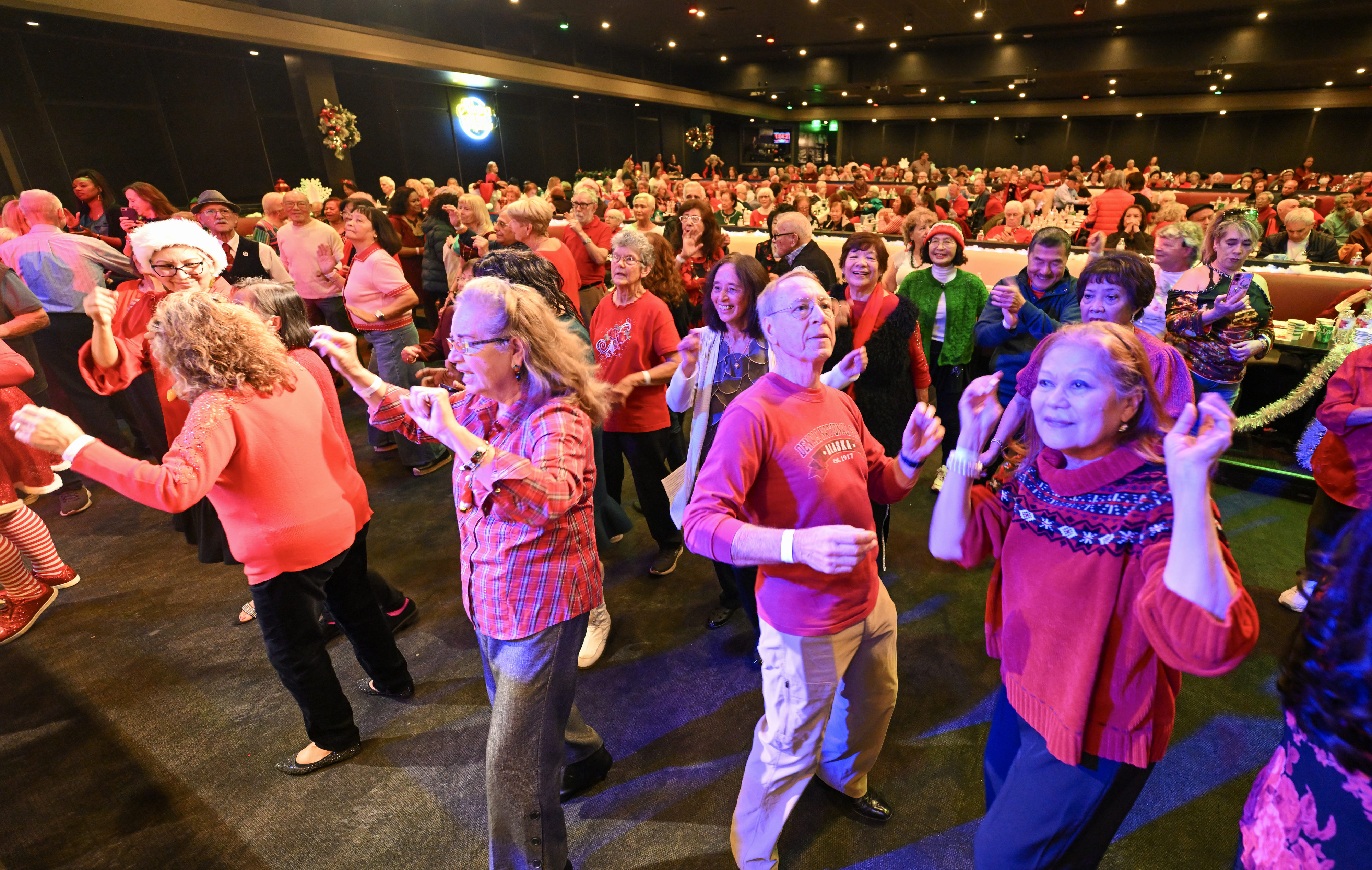 Jose and Maryanne Hernandez, right, joins other seniors as the...