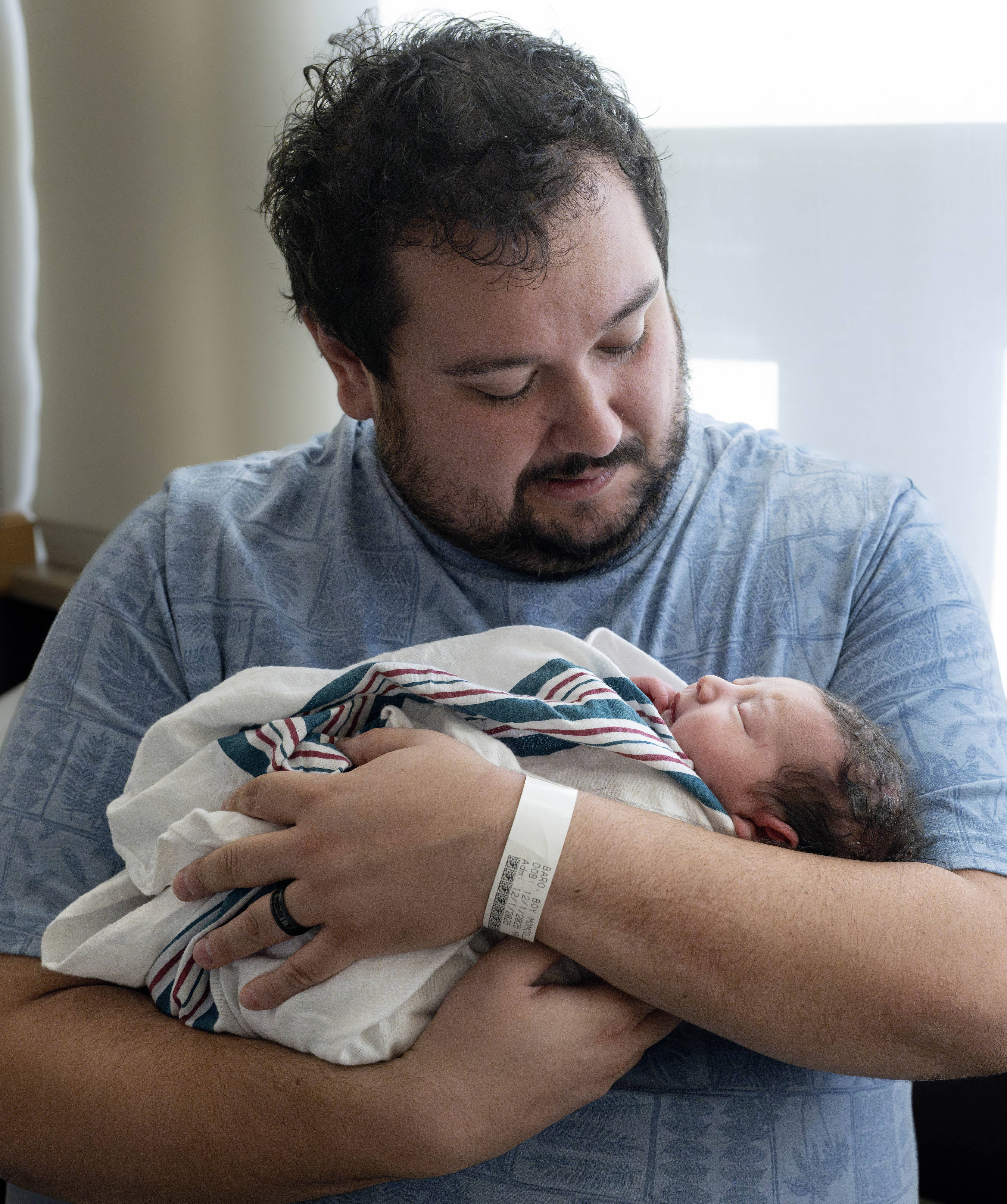 Jaime Baro holds his new baby, Andrew, at Providence St....