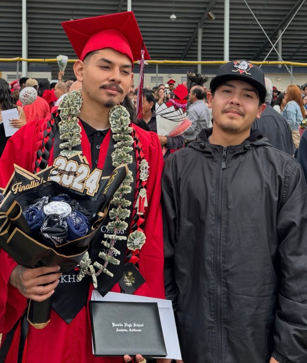 Alberto Arzola Jr., left, and Emmanuel Cordova at Arzola's graduation at Katella High School. (Courtesy of V. James DeSimone)