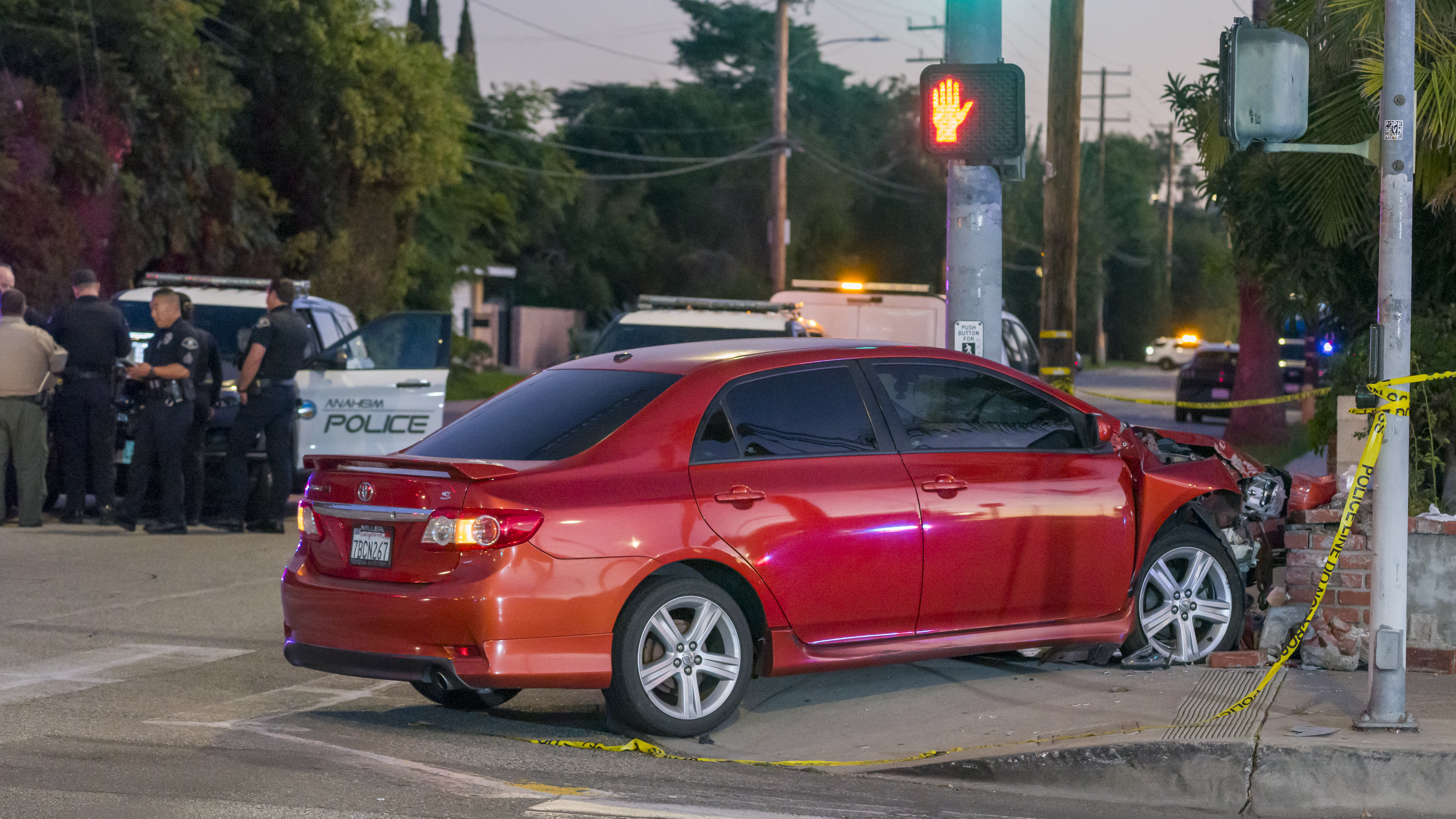 Anaheim Police gather at the intersection of Harbor Boulevard and...
