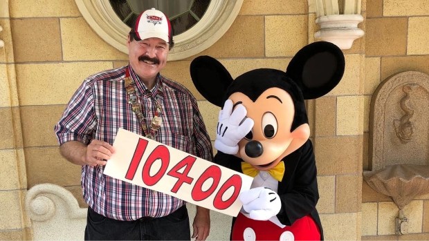Radiator Springs Racers record-holder Jon Hale marks his 10,400th ride with a dumfounded Mickey Mouse. (Courtesy of Jon Hale)