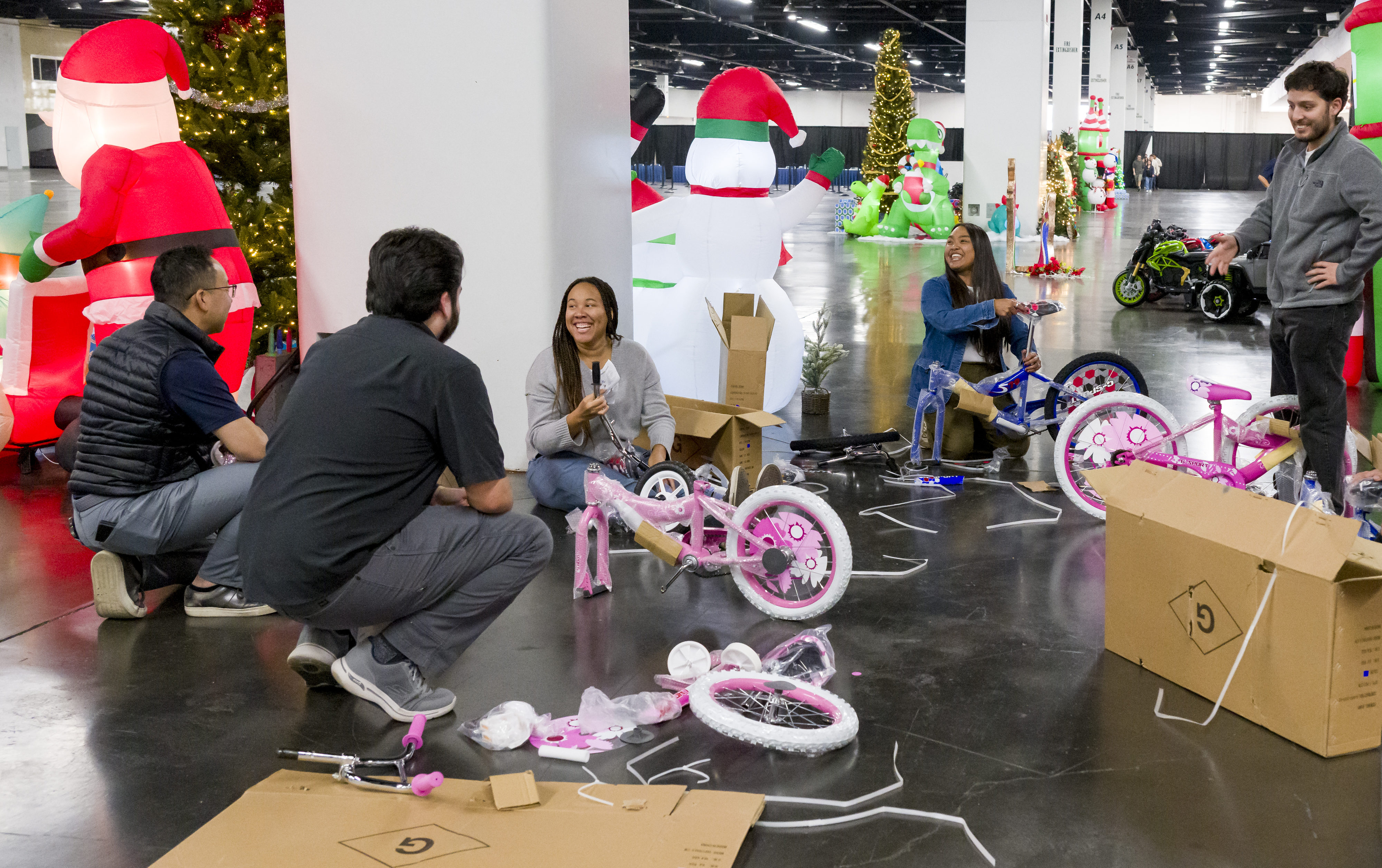 Volunteers assemble bicycles as they prepare for the Families Together...