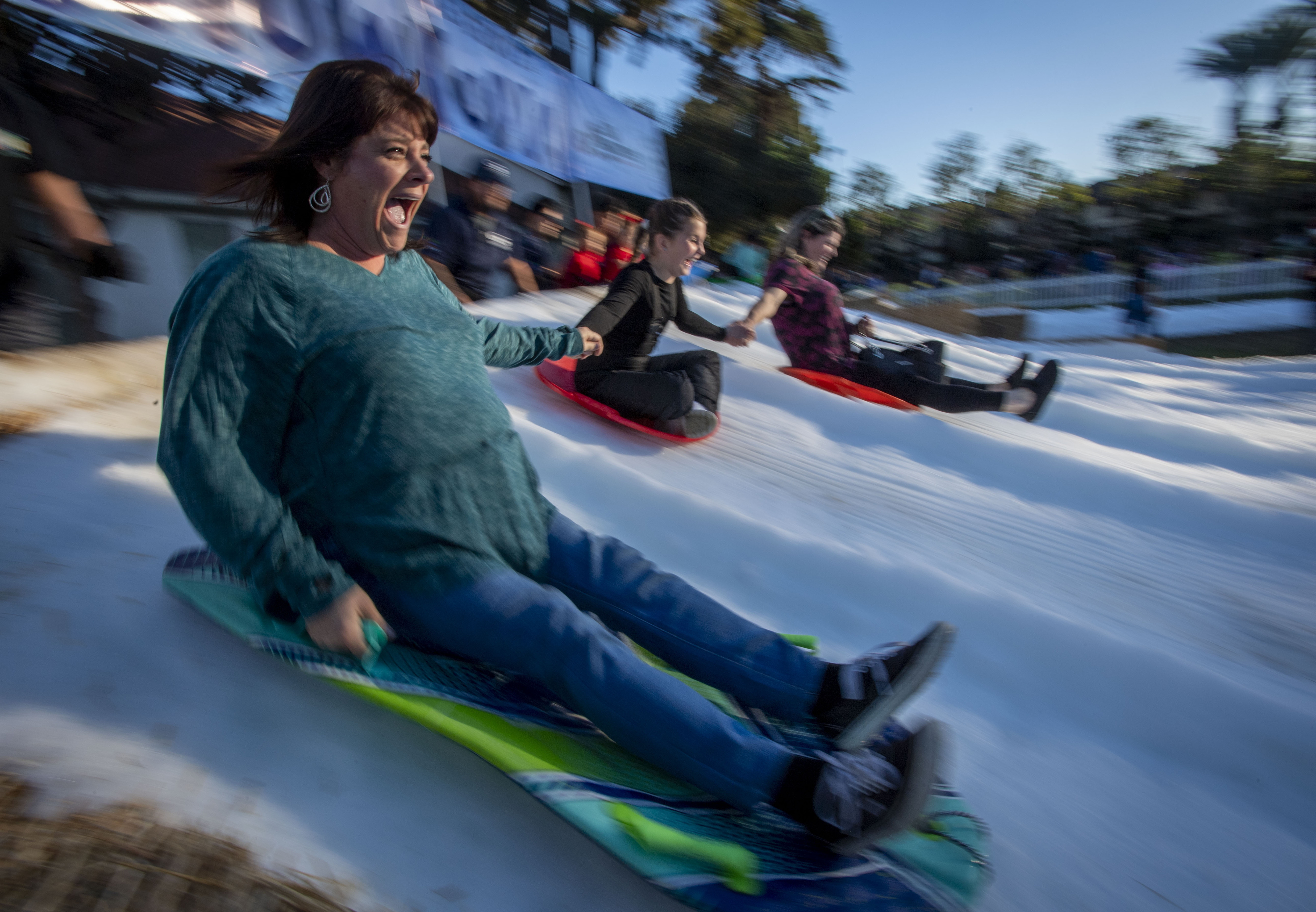 Aimee Gurnea, Peyton Gurnea and Melissa Clenney hold hands as...