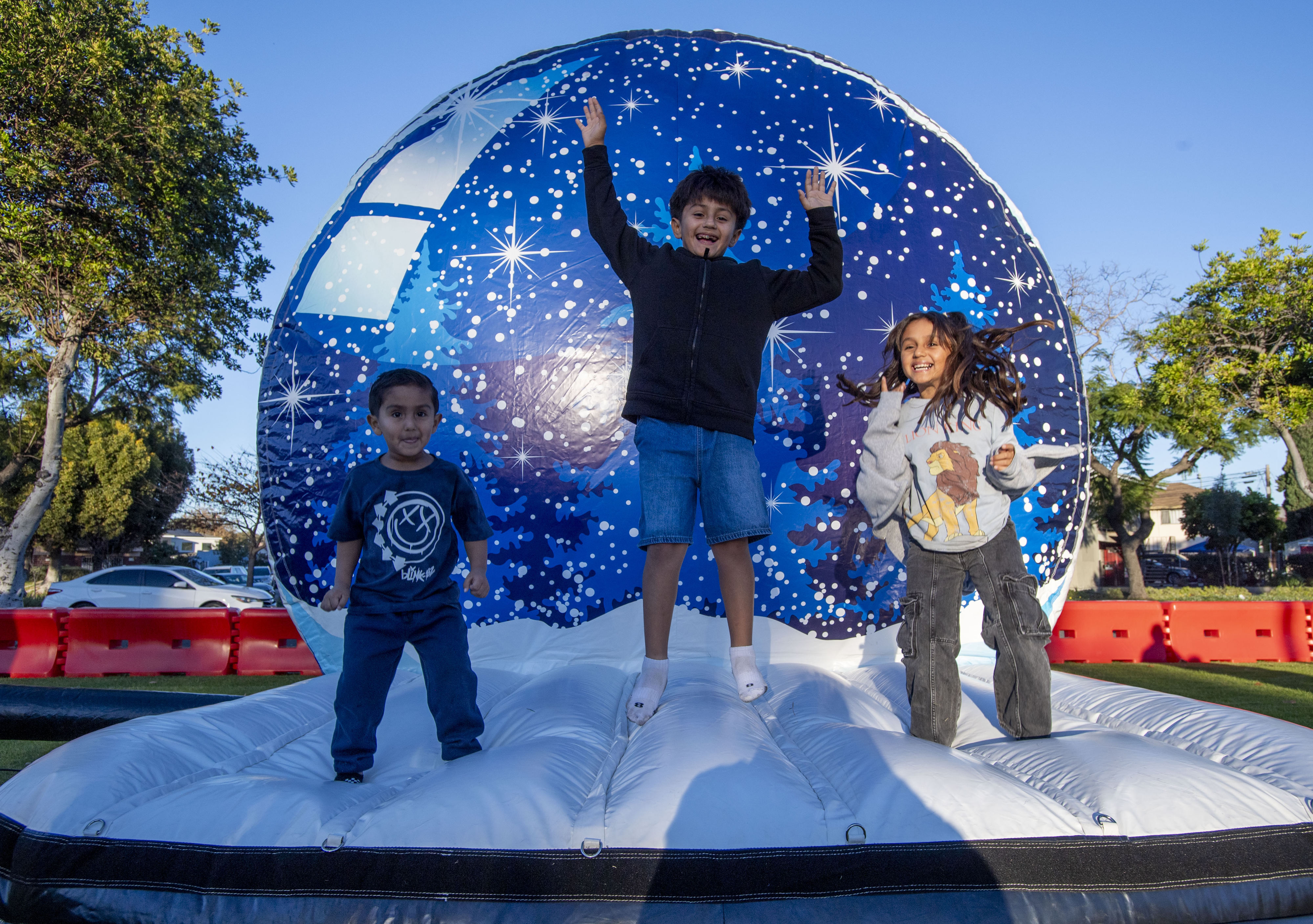Liam, Noah and Sophia Reyes enjoy a bouncy snow globe...