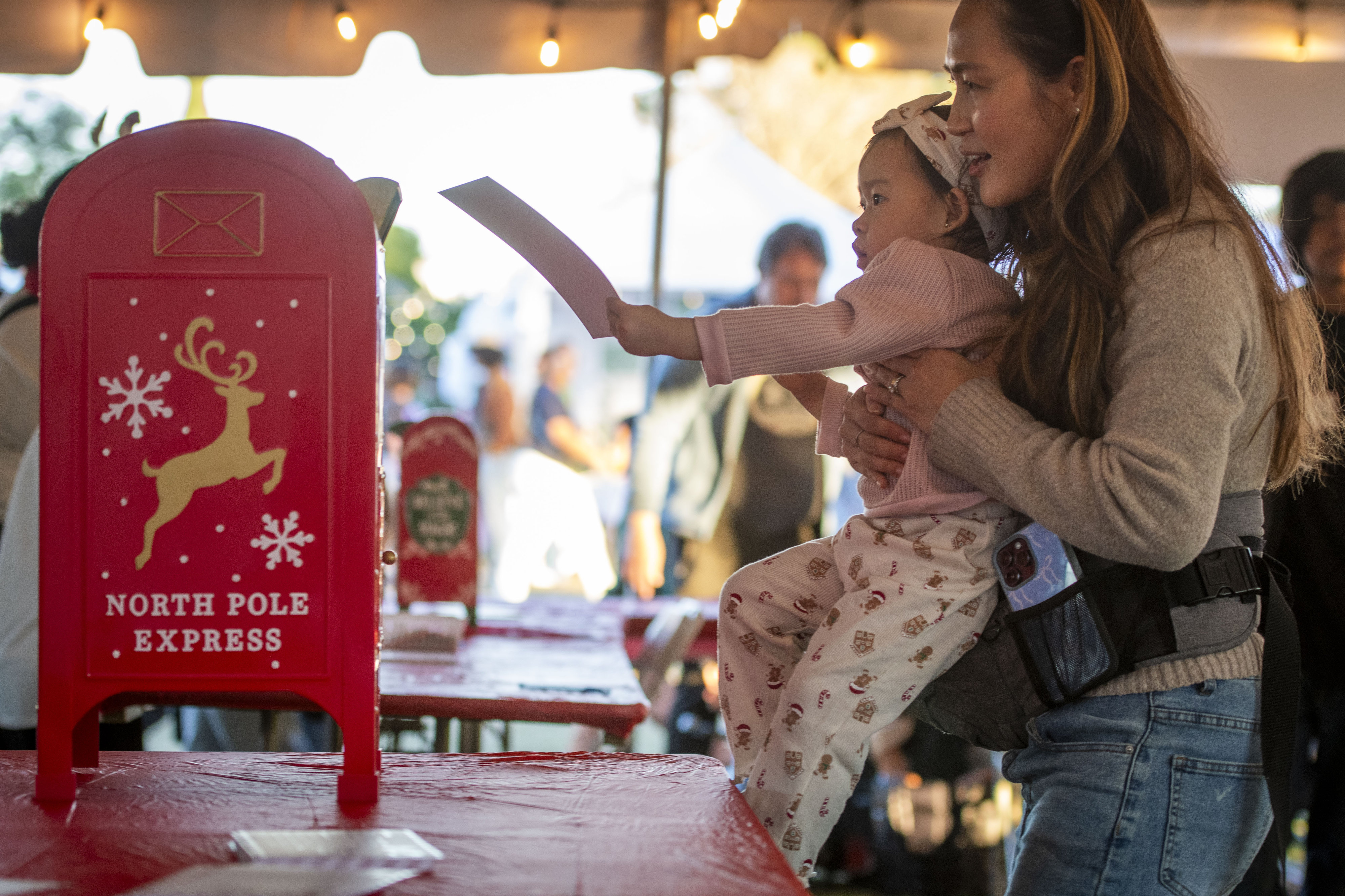 Mikayla Ngo helps her daughter, Mia Ngo, 2, send off...