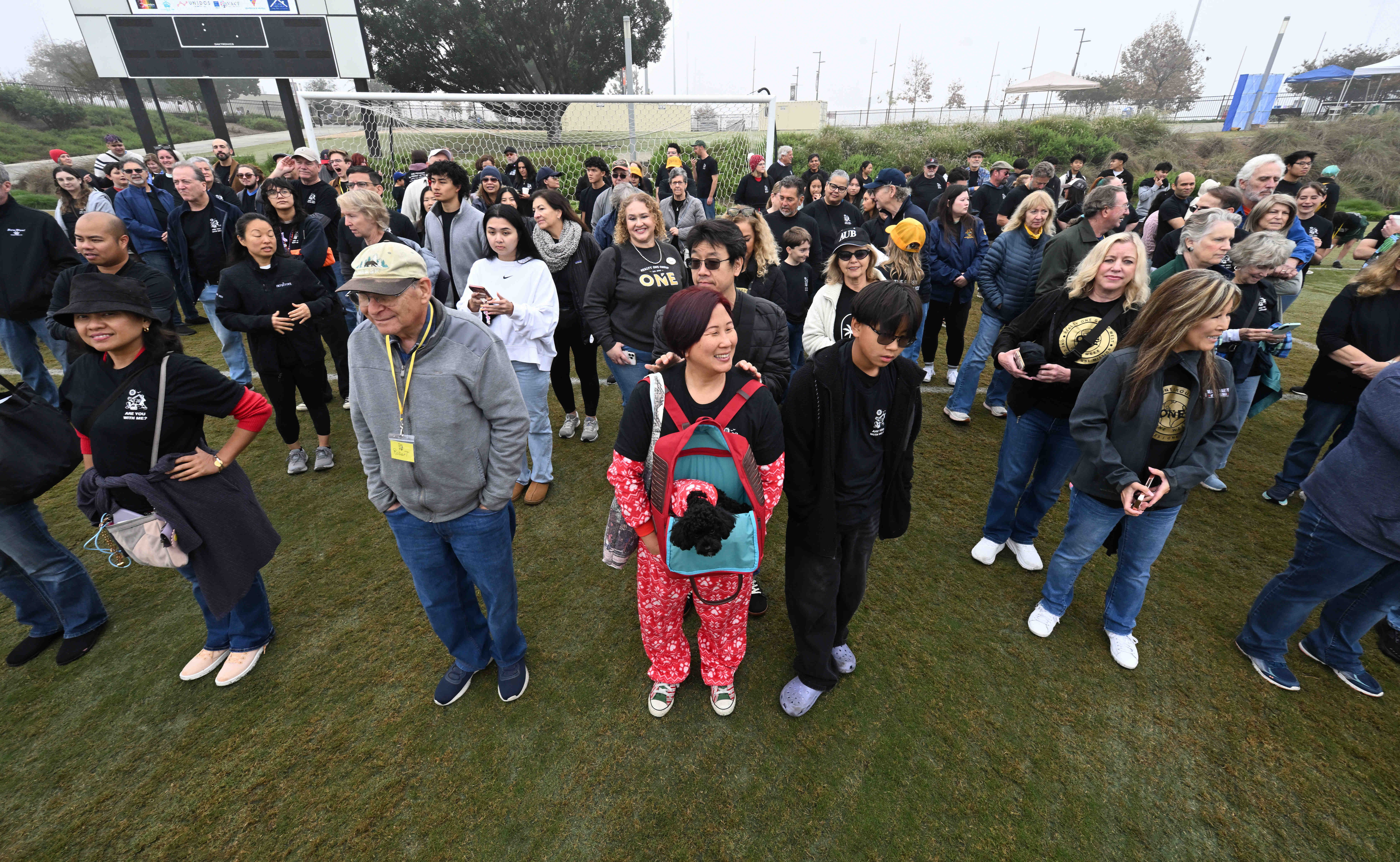 Volunteers gather at the Championship Soccer Stadium in Great Park,...