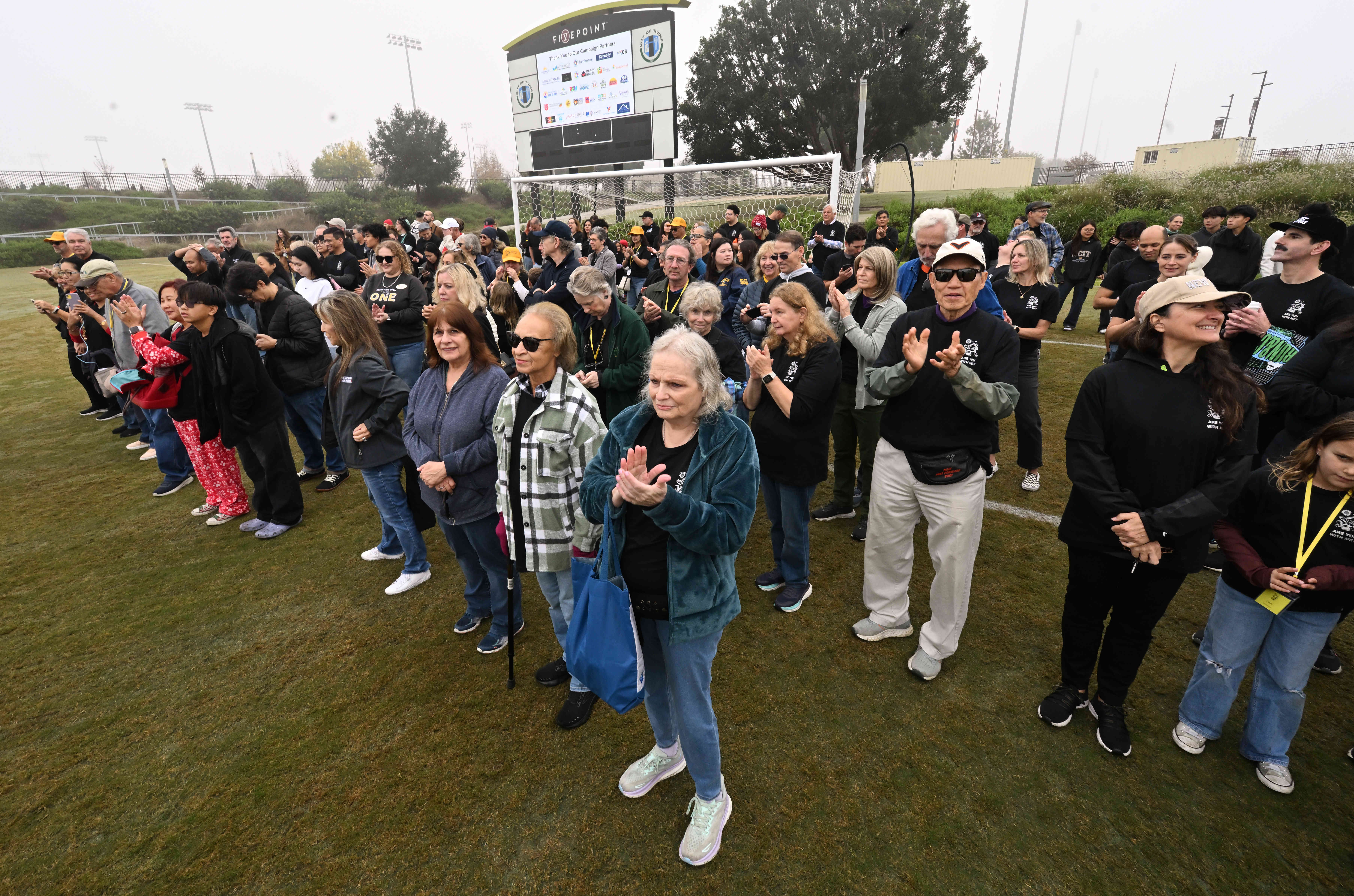 Volunteers gather at the Championship Soccer Stadium in Great Park,...