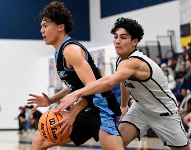 Mohammed el Baba #0 of Canyon reaches in for the ball against Nate Chung #24 of the Villa Park during a boys basketball game at Sonora High School on December 19, 2025 in La Habra, CA. (Photo by John McCoy, Contributing Photographer)