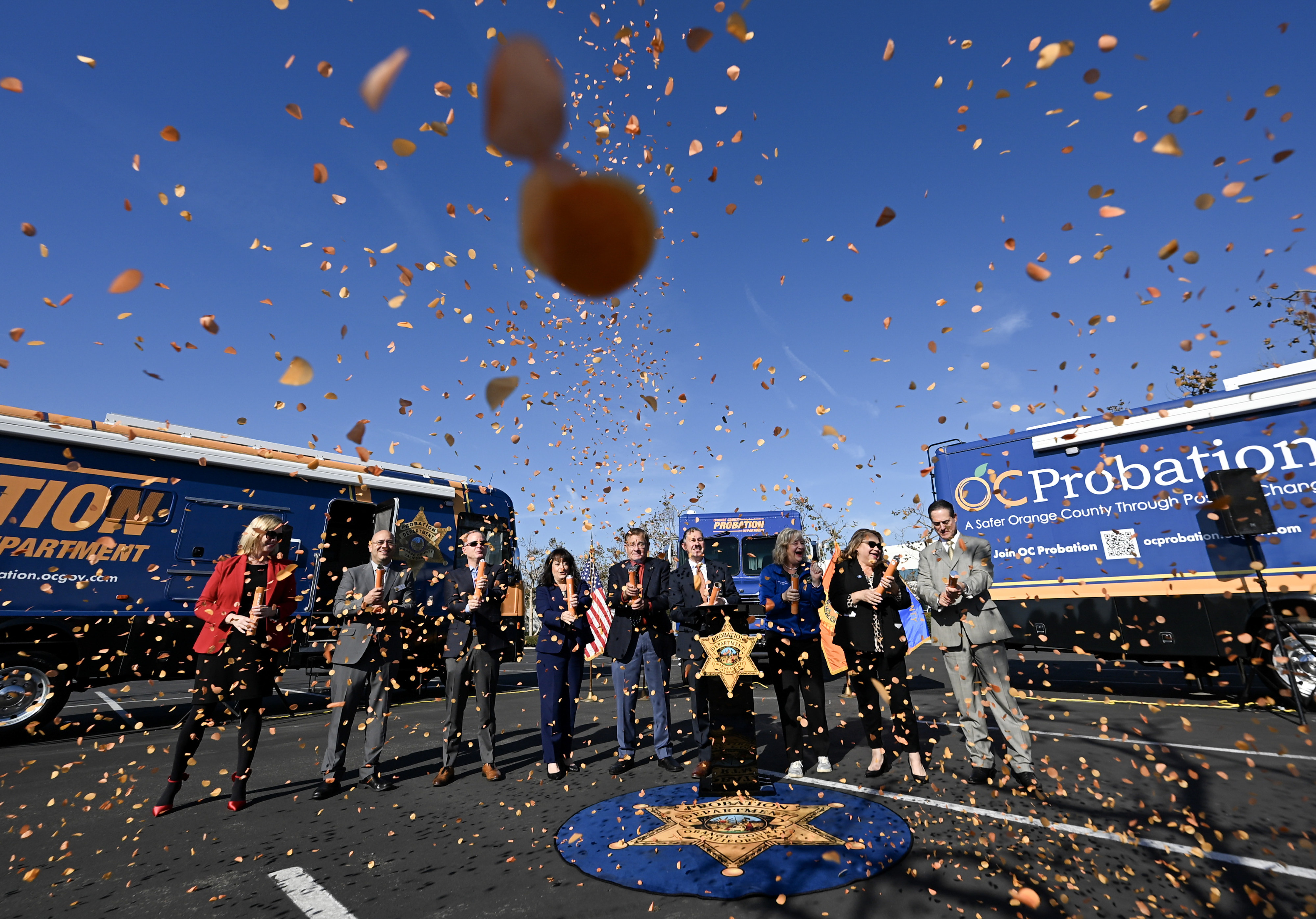 Officials pop confetti as the Orange County Probation Department unveil...