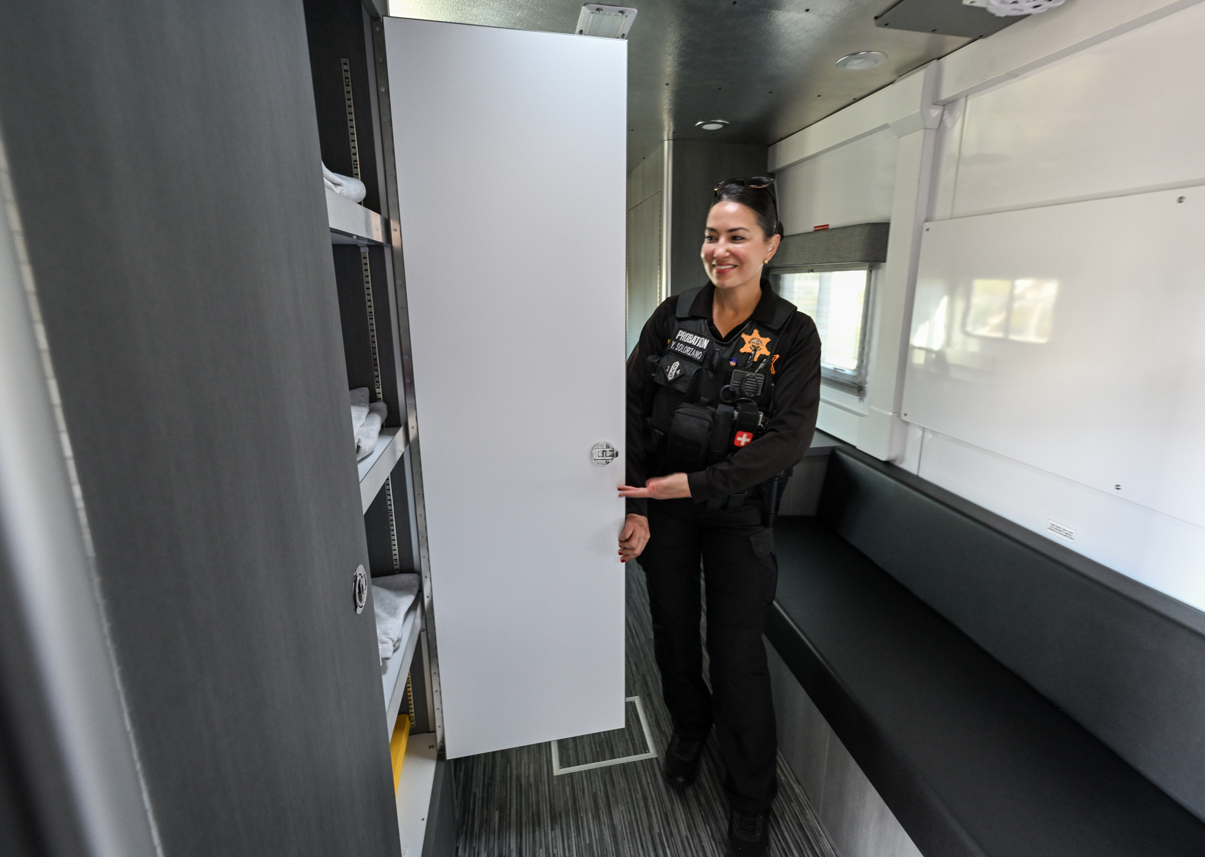 Probation Officer Yara Solorzano shows off a cabinet of court-approved...