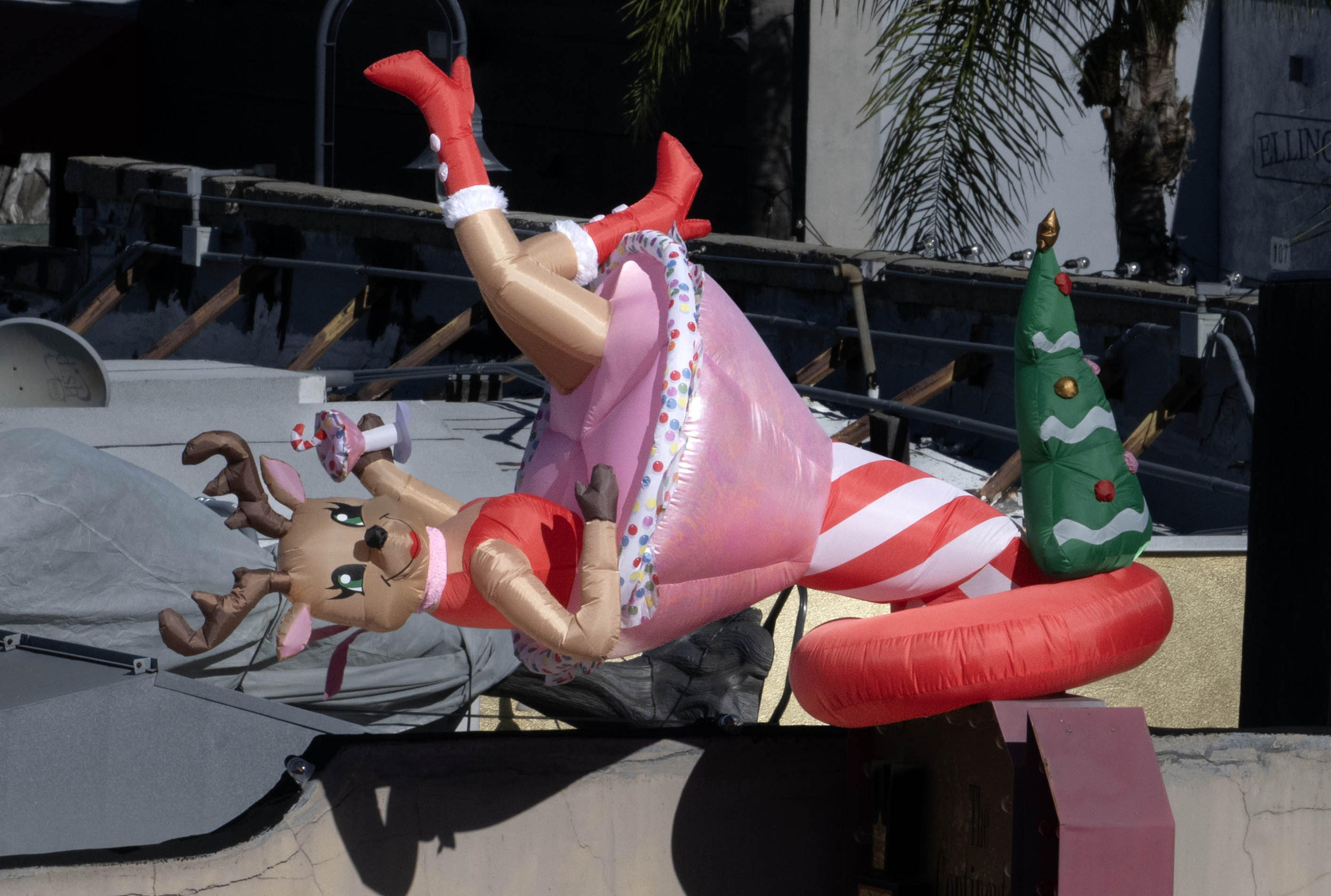 A Christmas decoration atop a building in Fullerton flips sideways...