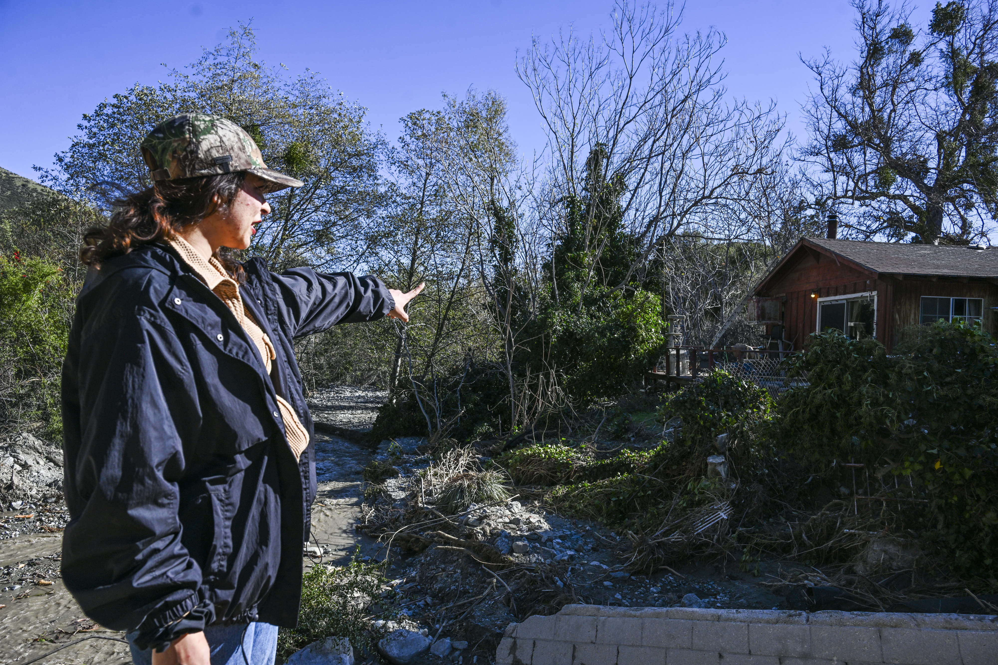 Therese Sorum, a Lytle Creek resident points out the property...