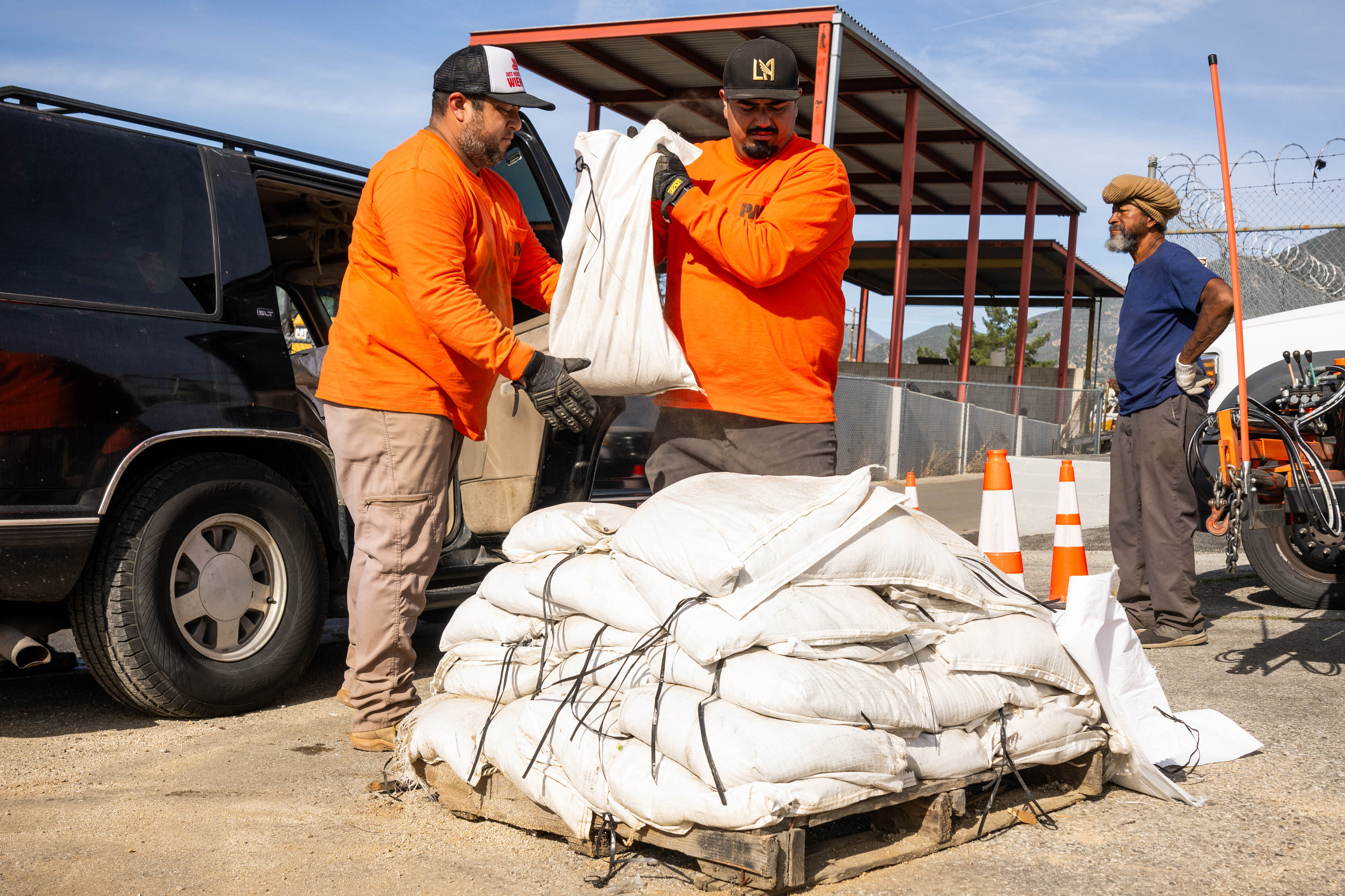 Los Angeles County Public Works crew loads sandbags in Donald...
