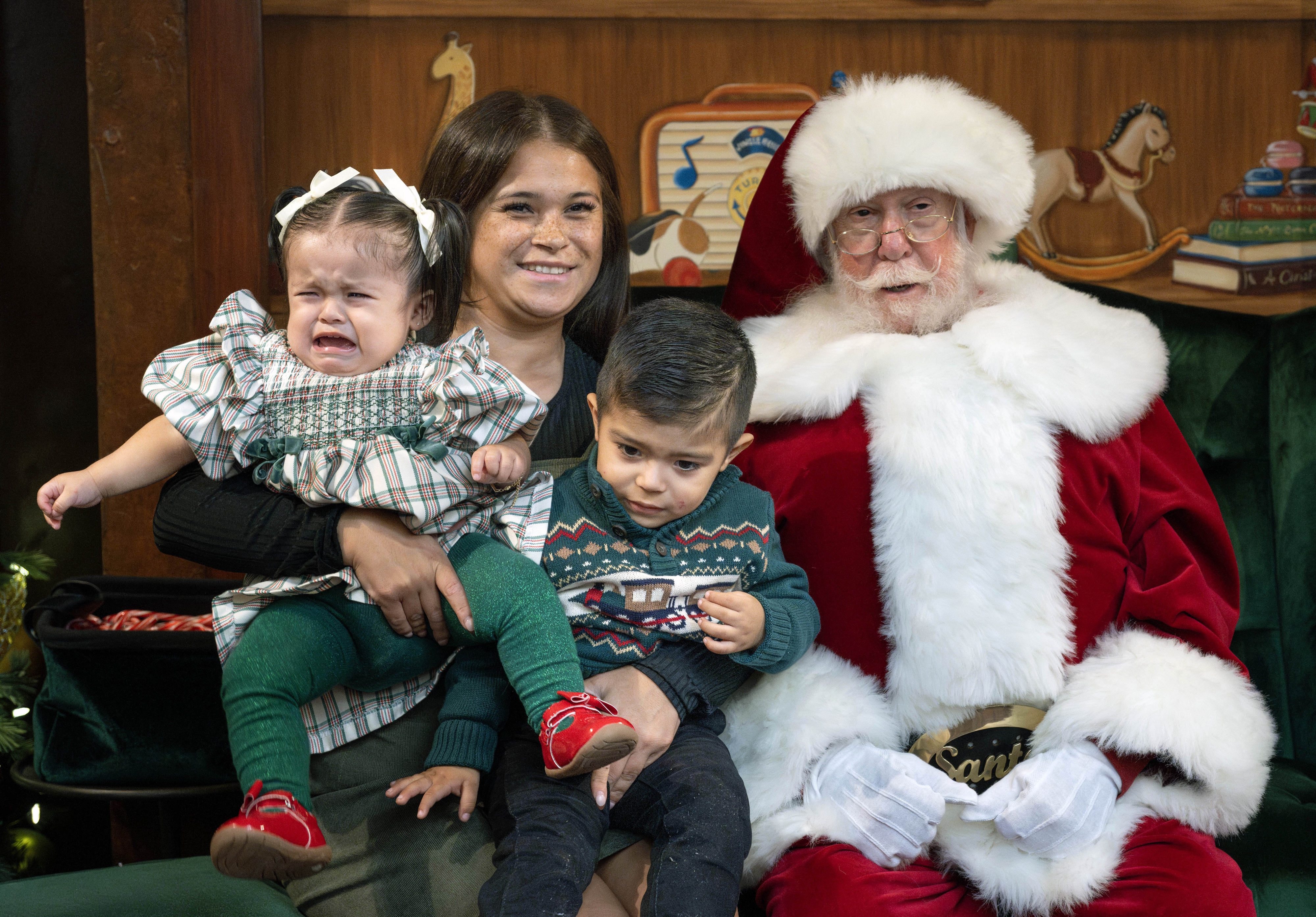 Cybelle Cortez manages a big smile even while her children,...