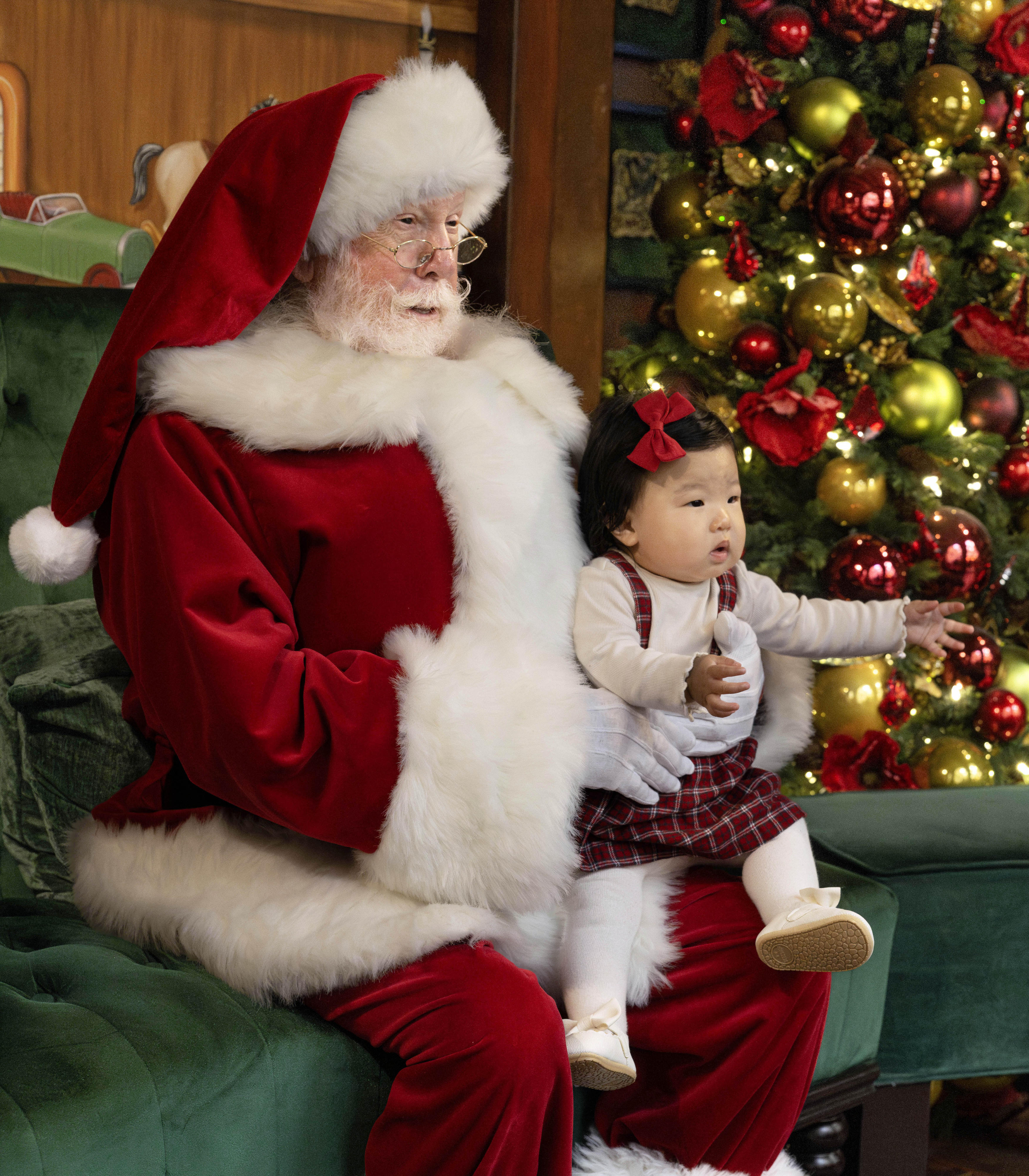 Harlow Gu, 8 months, sits with Santa at South Coast...
