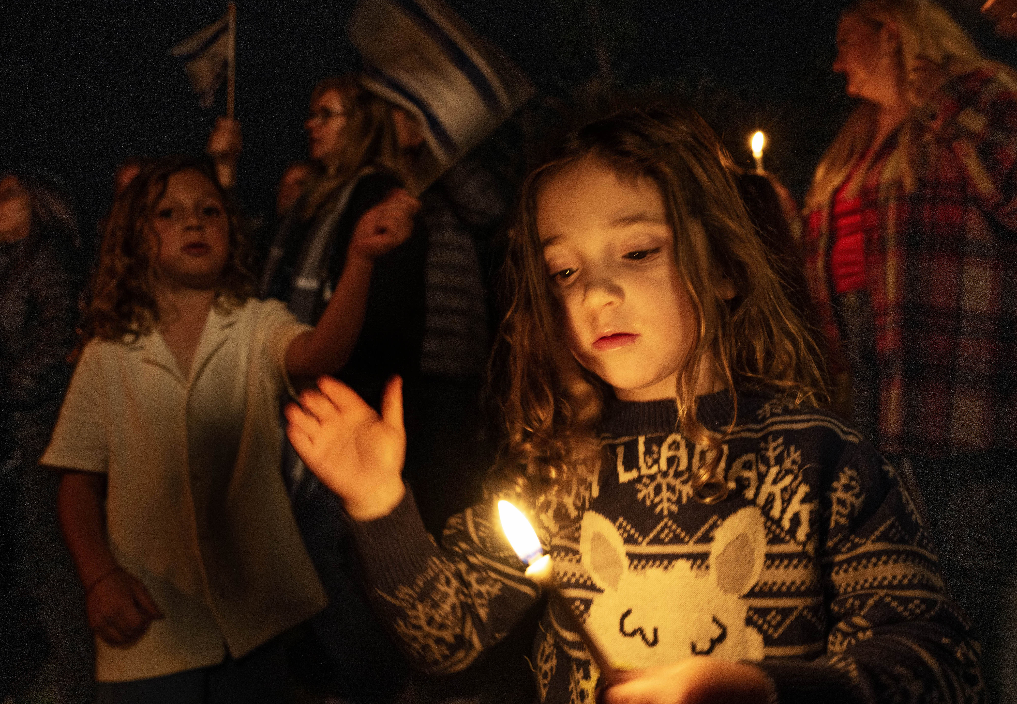 Three-year-old Charlie Klepin takes part in the annual pre-Hanukkah Menorah...
