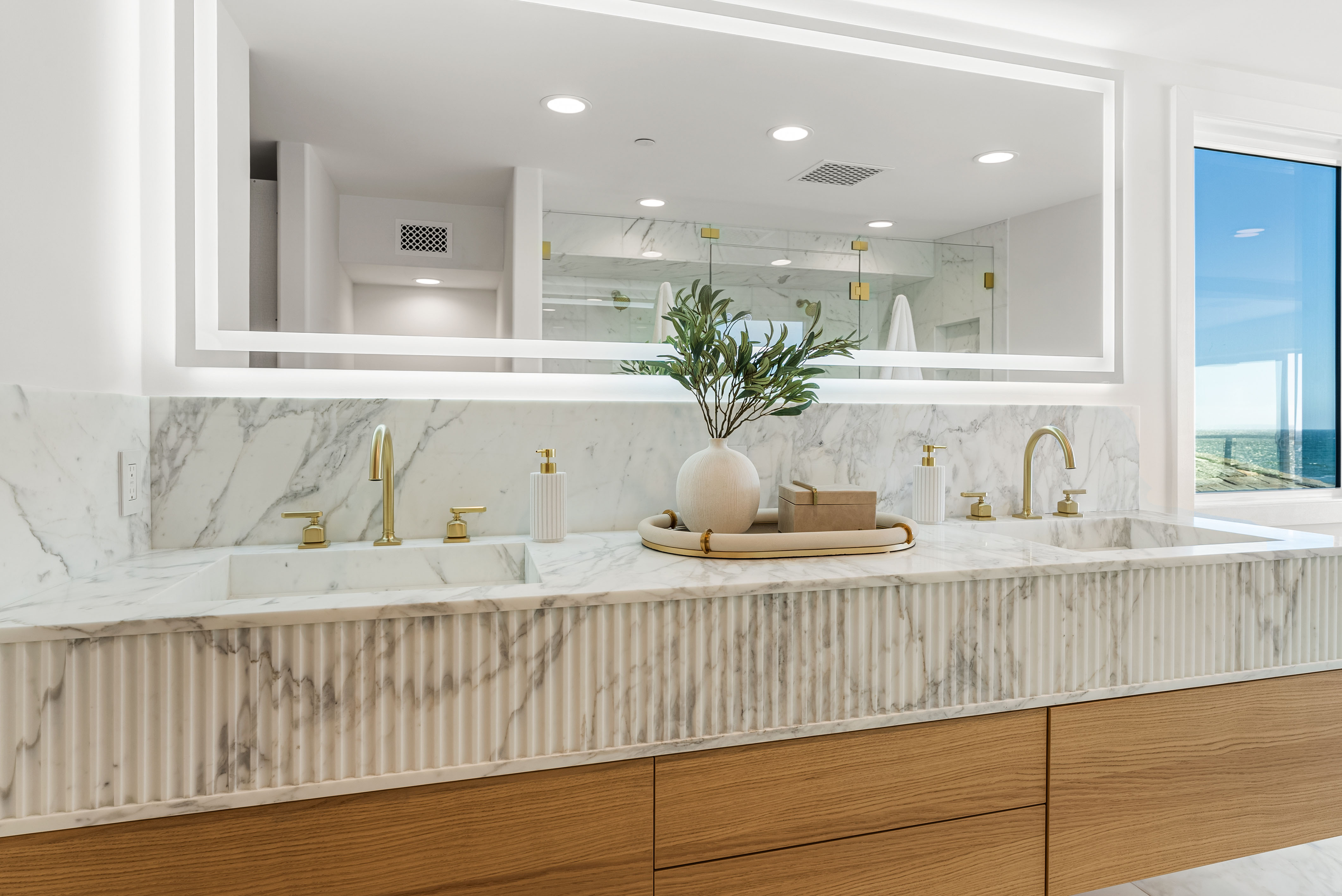 One of the primary bathrooms’ marble vanity. Photo by Deason...