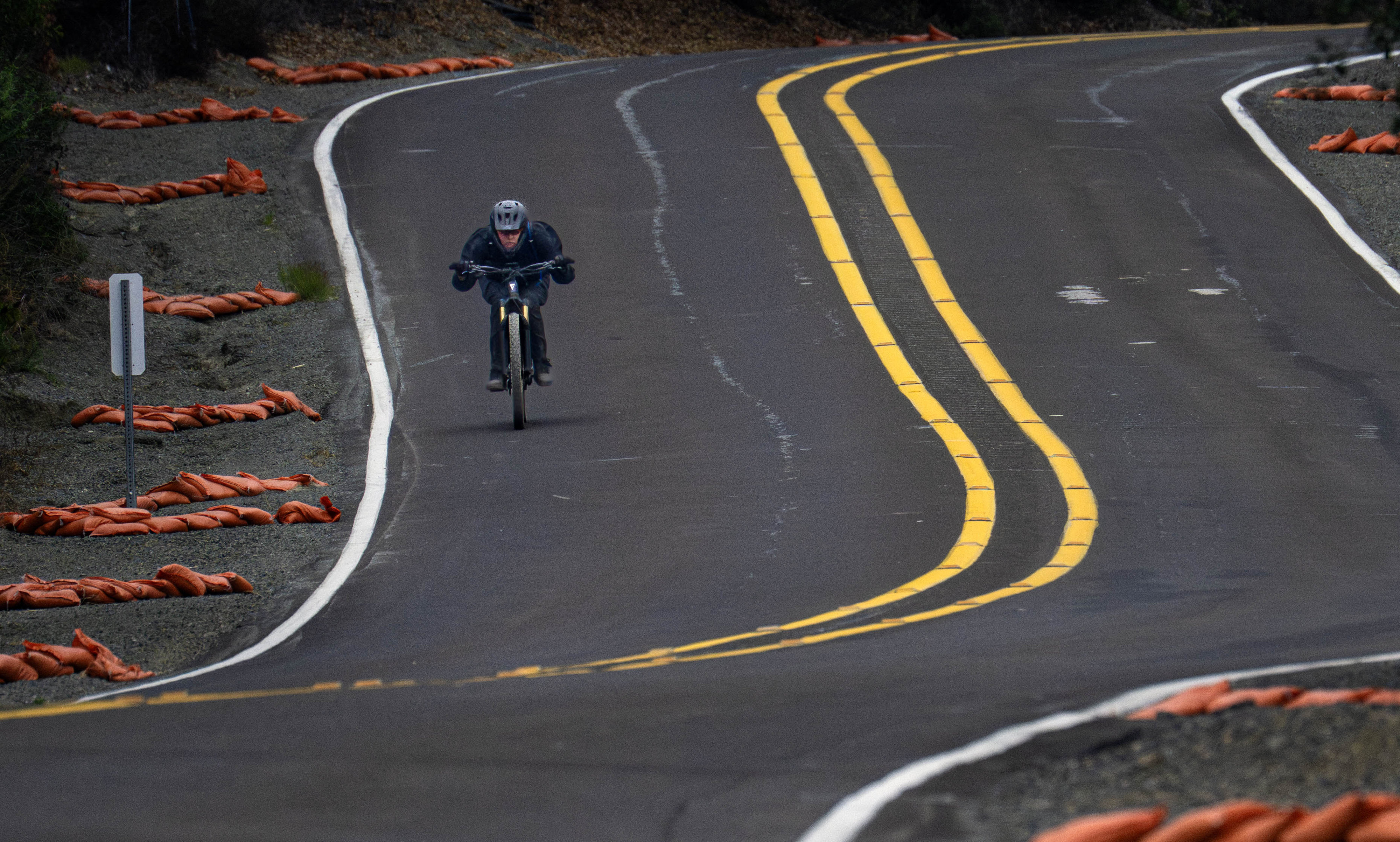 A mountain biker is positioned for a fast downhill on...