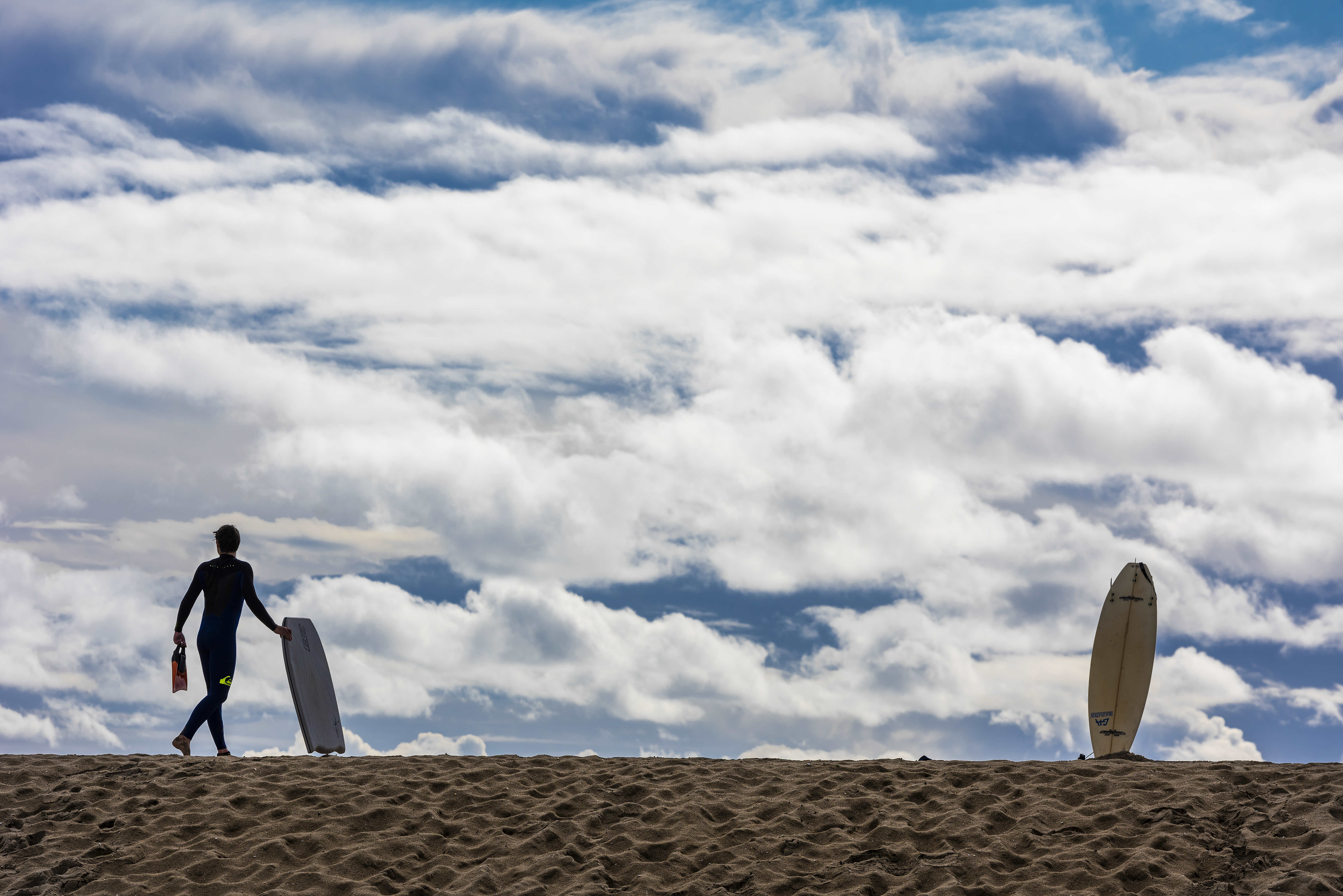 Dylan Hameister, 16, of Seal Beach carries his body board...