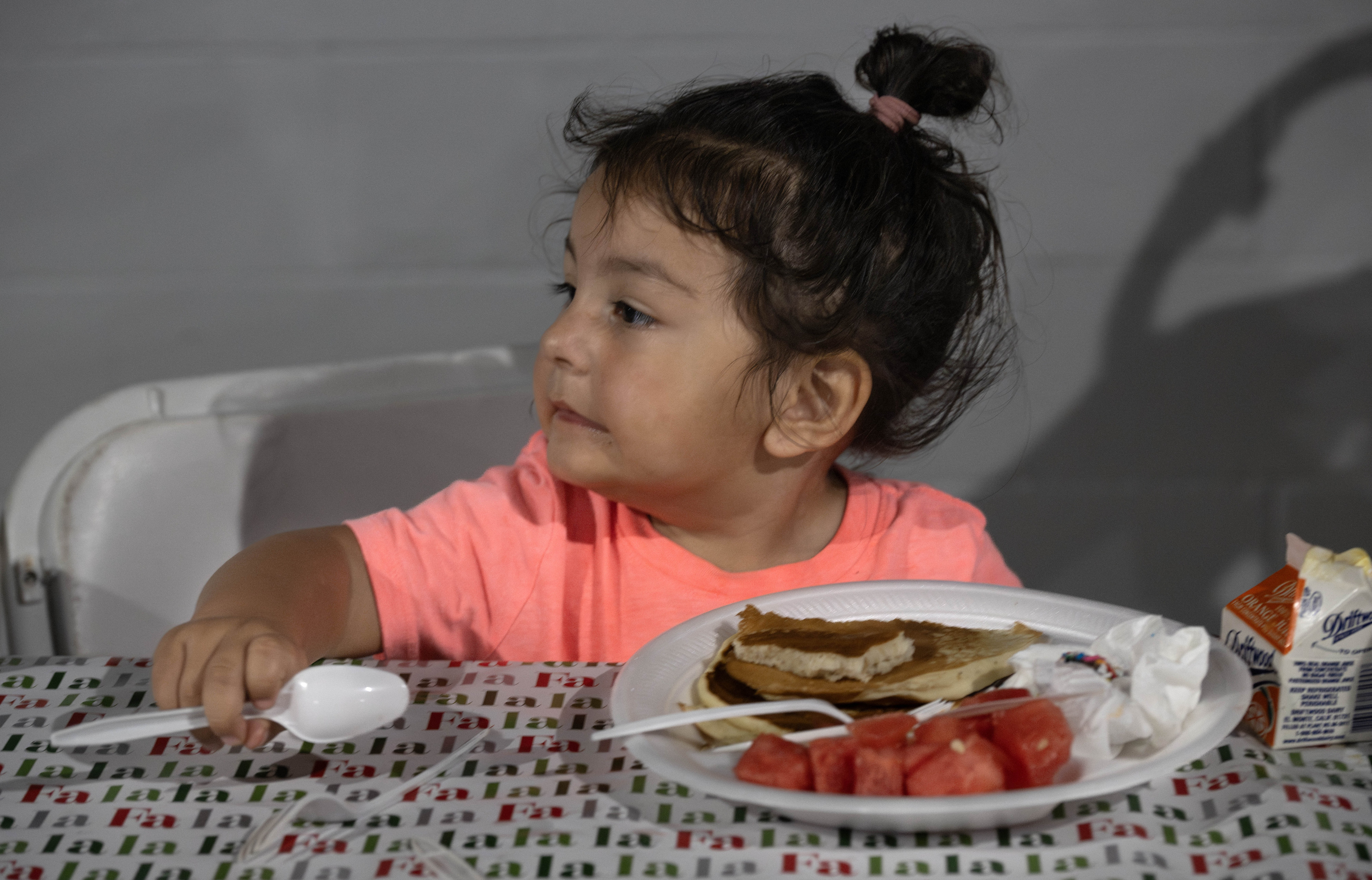 Two-year-old Olivia Cruz enjoys a pancake breakfast during the annual...