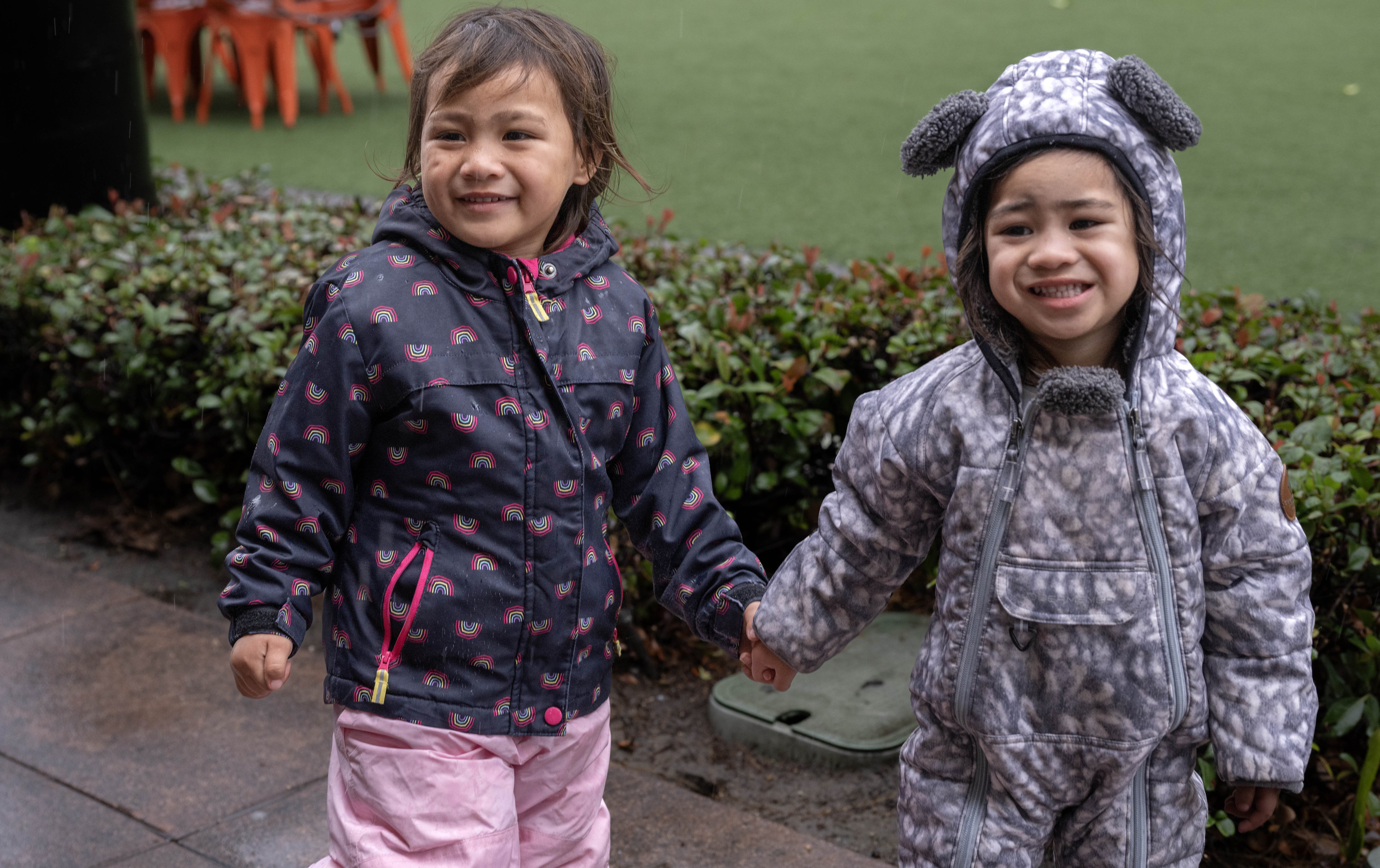 Sisters Kawena Maae, 3, left, and Pualena, 2, stay close...