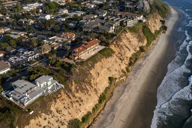 An aerial view of houses along a coastal bluff at Boneyard Beach in Encinitas in 2024. (Photo by Adriana Heldiz, CalMatters)