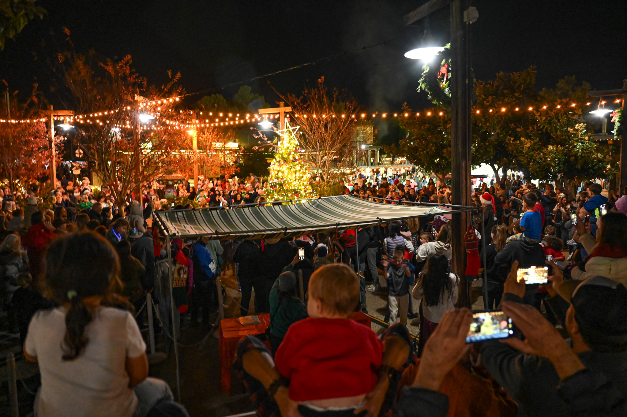 Hundreds of people were gathered throughout the Old Poway Park...