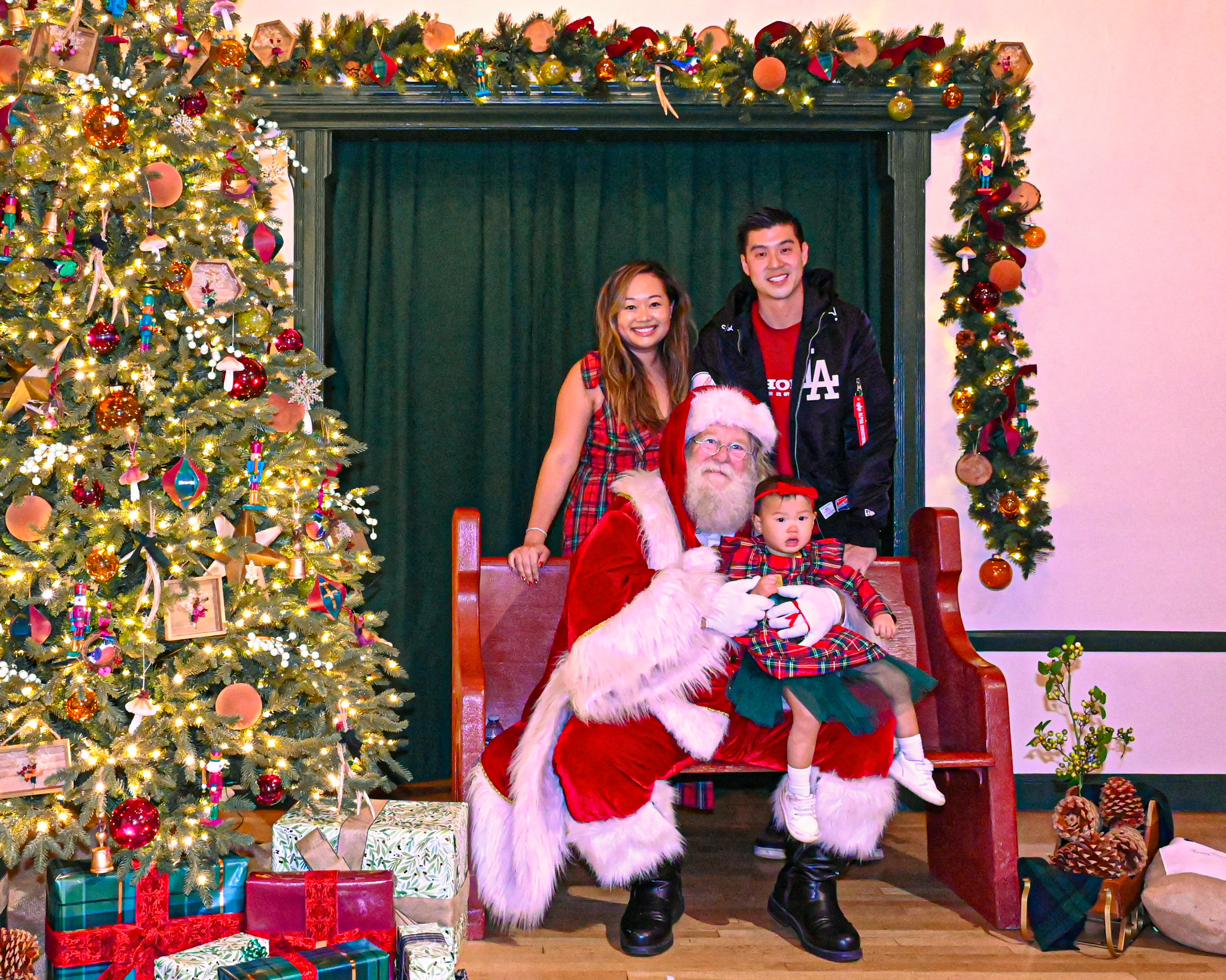 From left, Ching-Yun Li, Santa holding Kylie, and Calvin Hsu....
