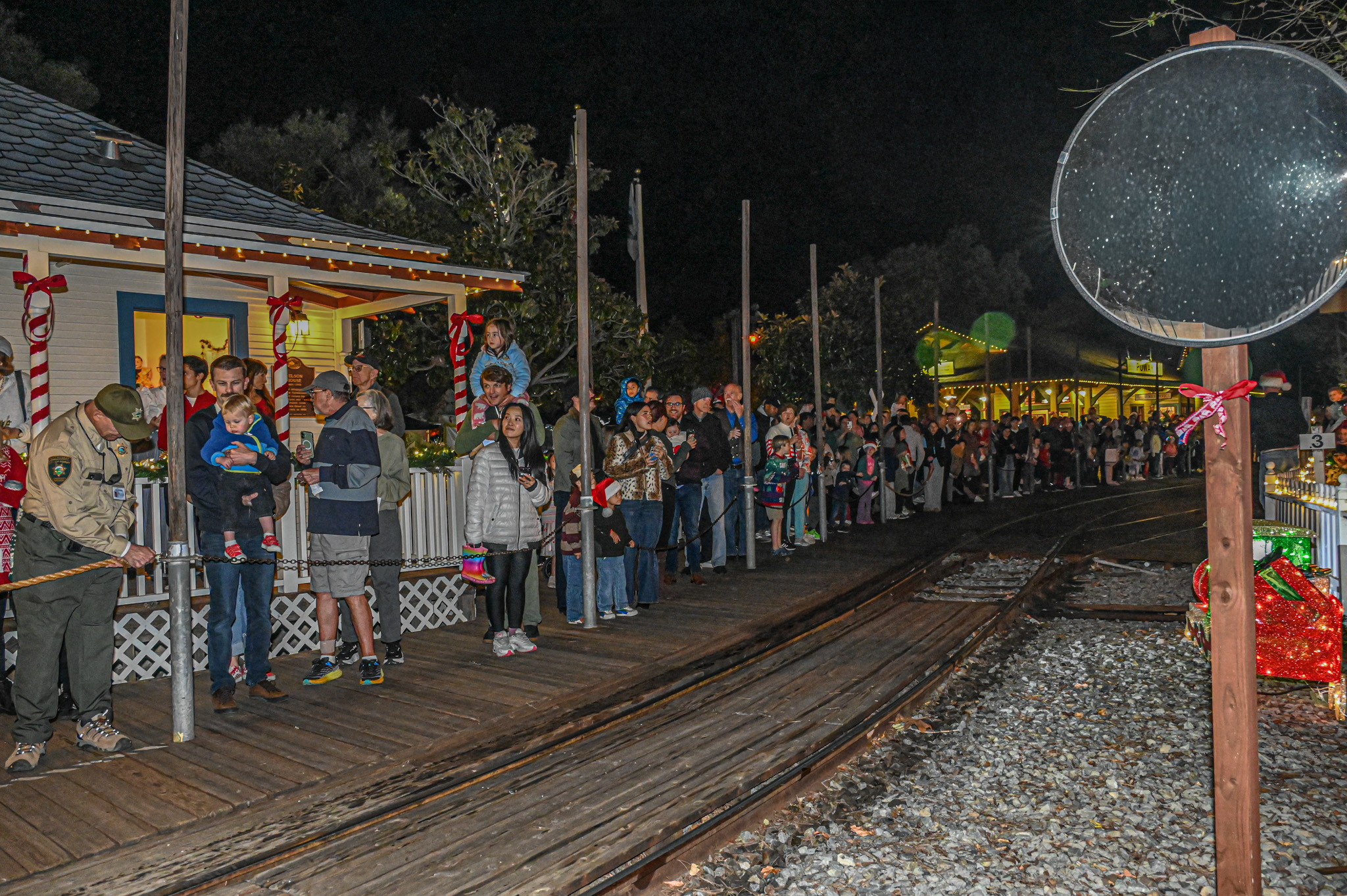 Hundreds of people line the boardwalks next to the train...