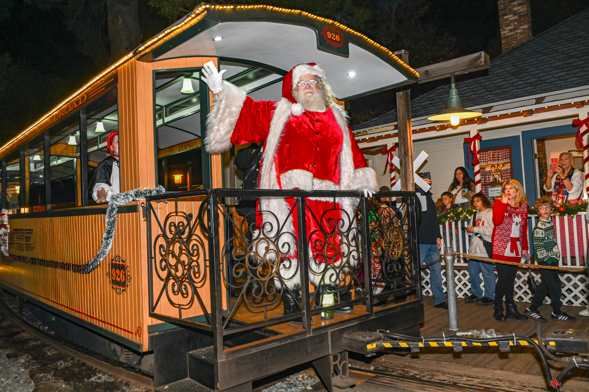 Santa waves from the Poway Midland passenger car as it...