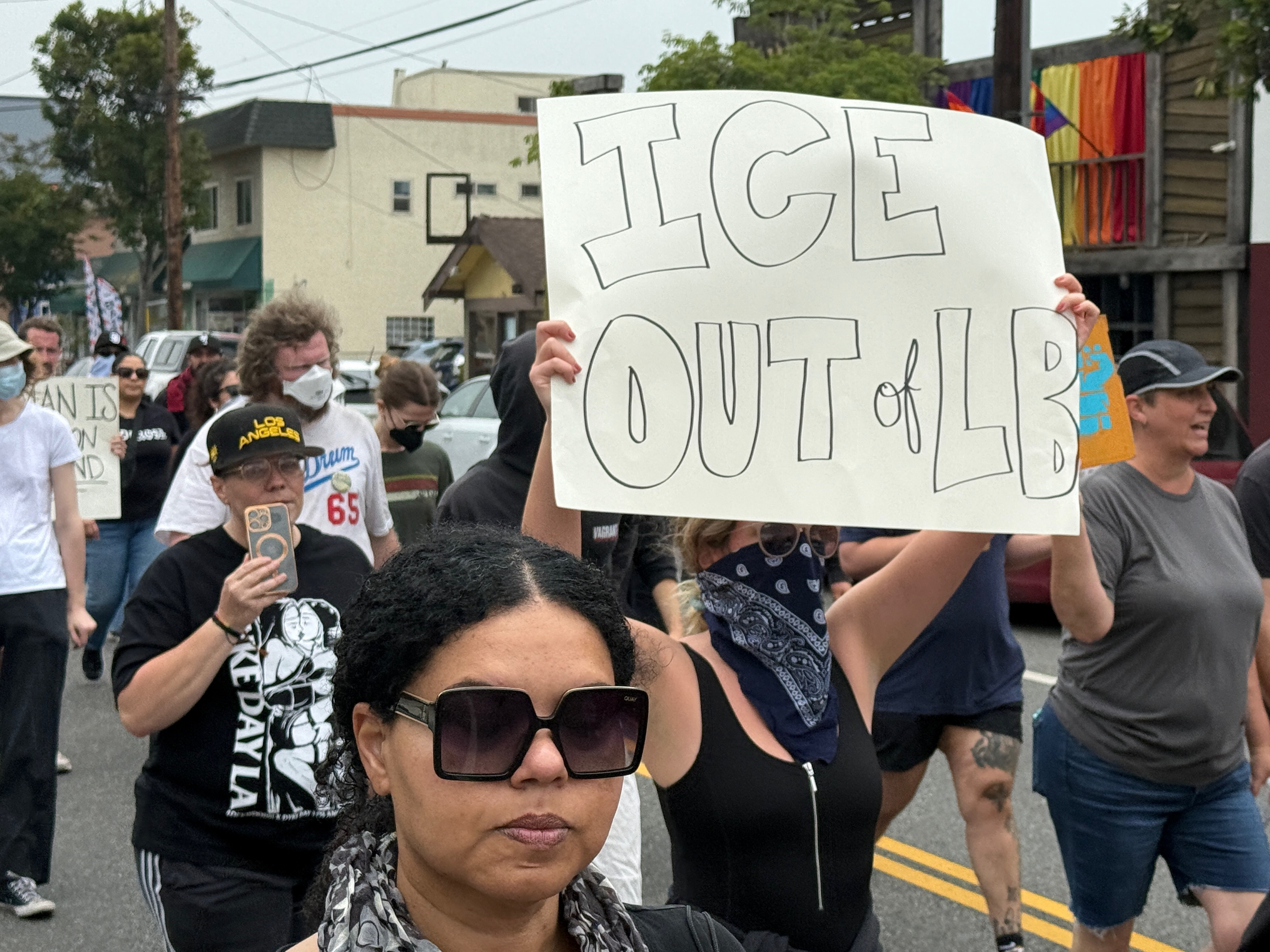 Dozens of protesters shouting anti-ICE chants march along Broadway in...