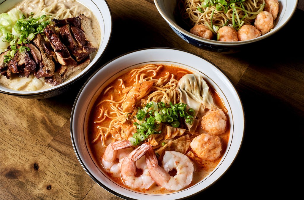 Overhead shot of a bowl of shrimp noodle soup with whole noodles and meatballs at Le Shrimp Noodle Bar.