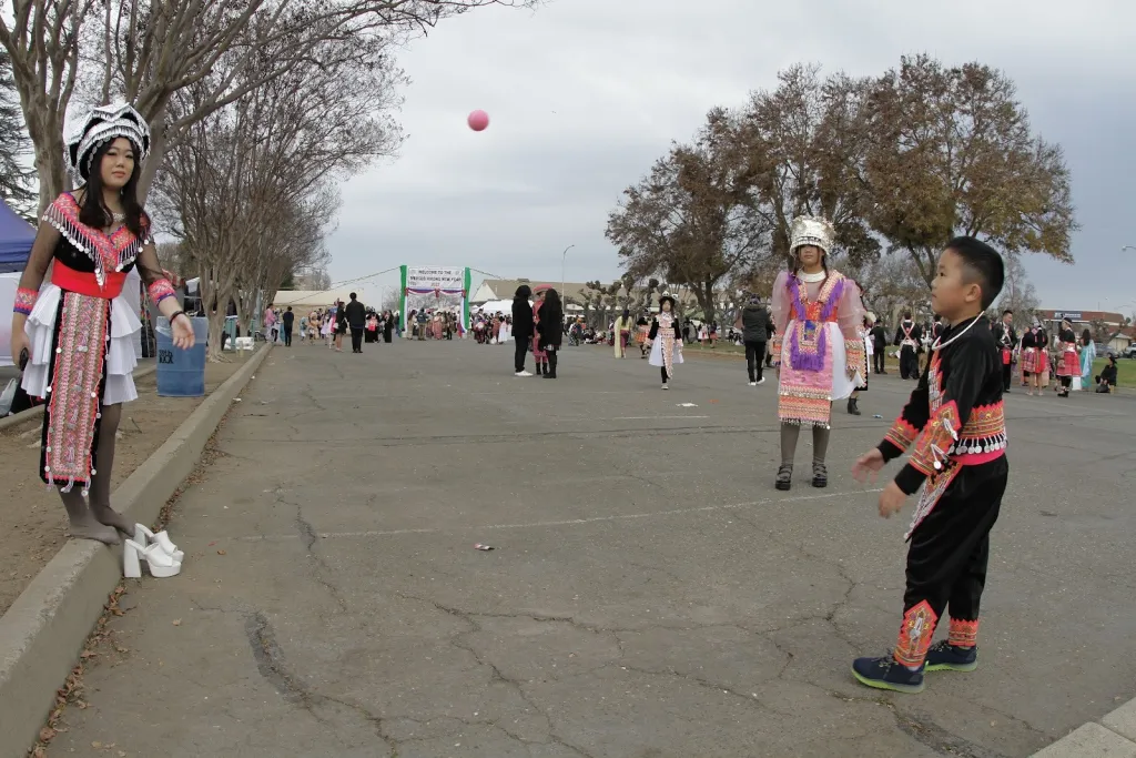 A group of Hmong children play Pov Pob, a ball-tossing game, during the 2023 Hmong New Year Celebration.